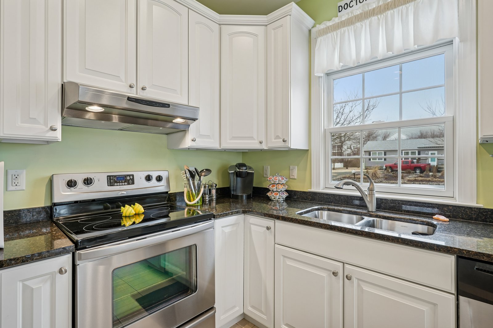 Cook up your favorites in this bright, fully-equipped kitchen with granite countertops, stainless appliances, and a sunny window view.