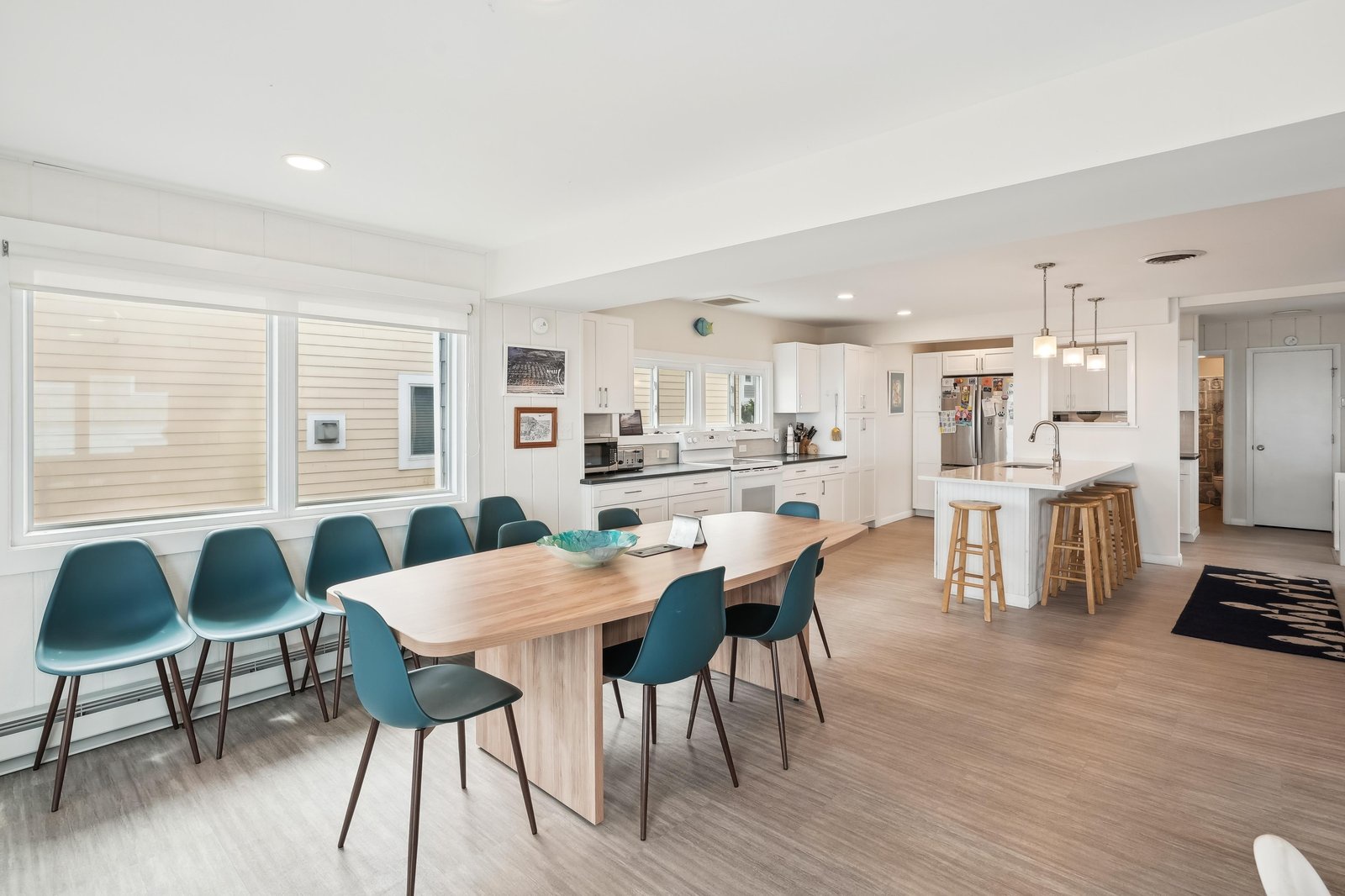 Gather everyone around this spacious dining table that flows seamlessly into your fully-equipped kitchen—perfect for cooking together and creating memories over shared meals.