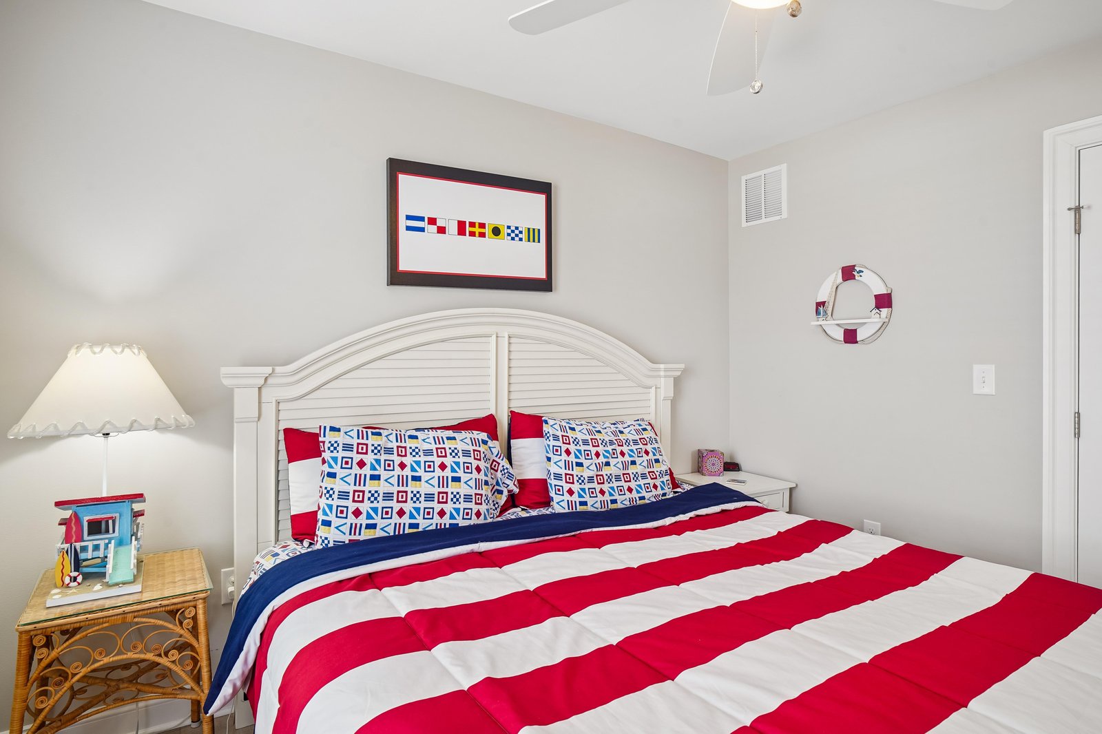 Step into your coastal retreat, where crisp white furnishings and nautical touches create a refreshing seaside vibe. A ceiling fan keeps you cool while cheerful decor and comfortable bedding invite restful nights after a day of sun and exploration.