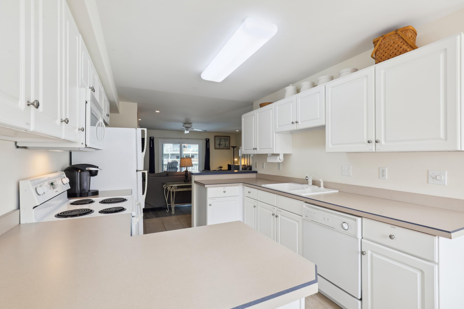 You'll love cooking in this bright, spacious kitchen with everything at your fingertips—crisp white cabinets, ample counter space, and all the appliances you need to whip up a memorable meal during your stay.