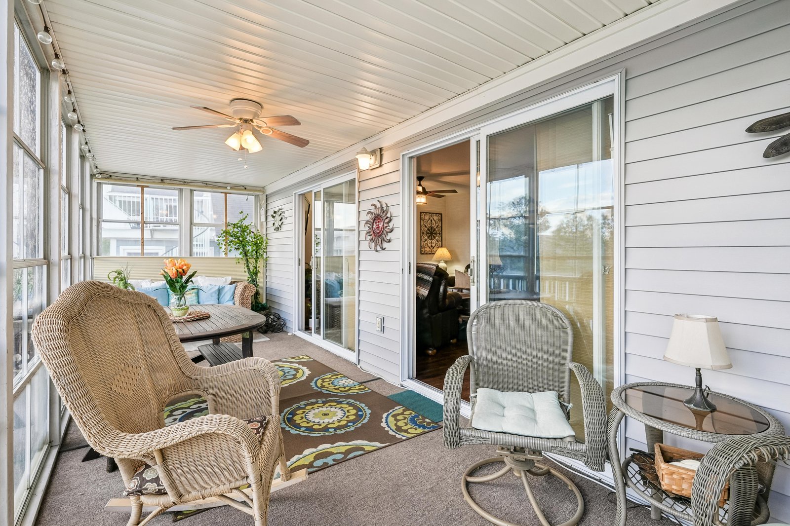 Step into your private sunroom retreat, perfect for morning coffee or evening relaxation with cozy wicker seating, soft lighting, and cheerful garden views welcoming you to unwind.