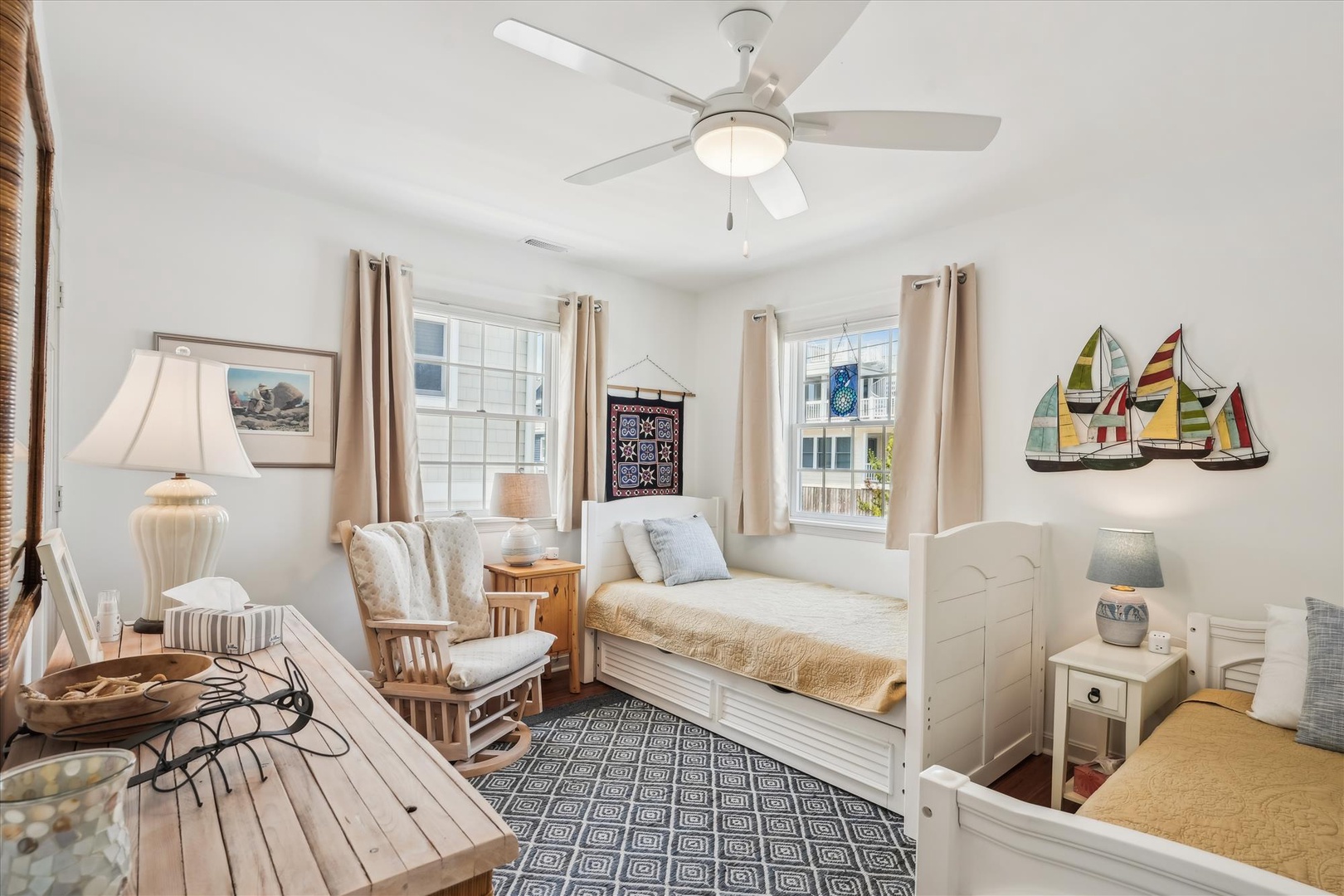Unwind in your light-filled retreat with coastal charm. Enjoy a restful daybed, cozy seating, and nautical accents that make you feel right at home by the sea.