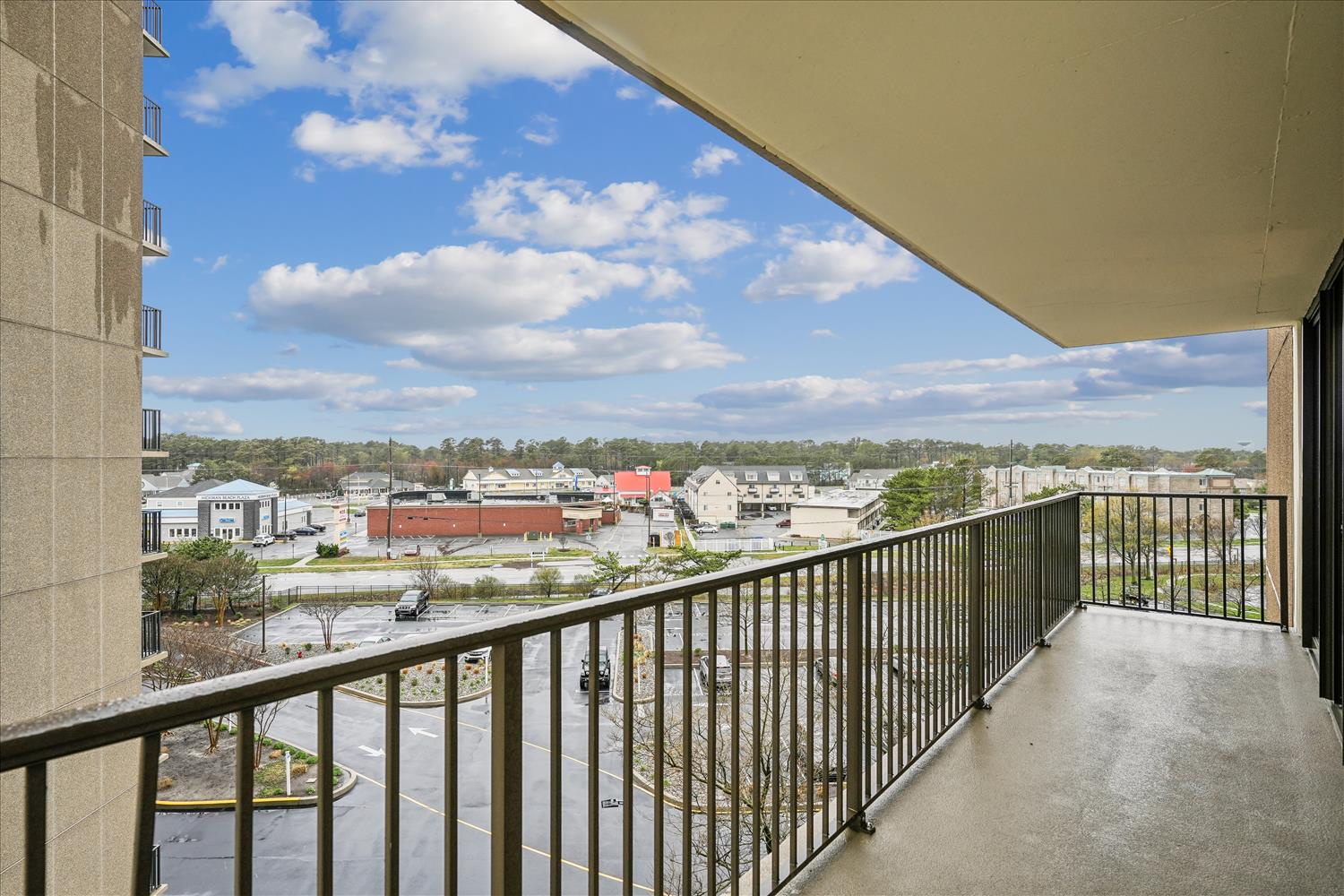 Private balcony offering open views across the surrounding neighborhood and tree-lined streets, perfect for morning coffee or watching the sky change throughout the day.
