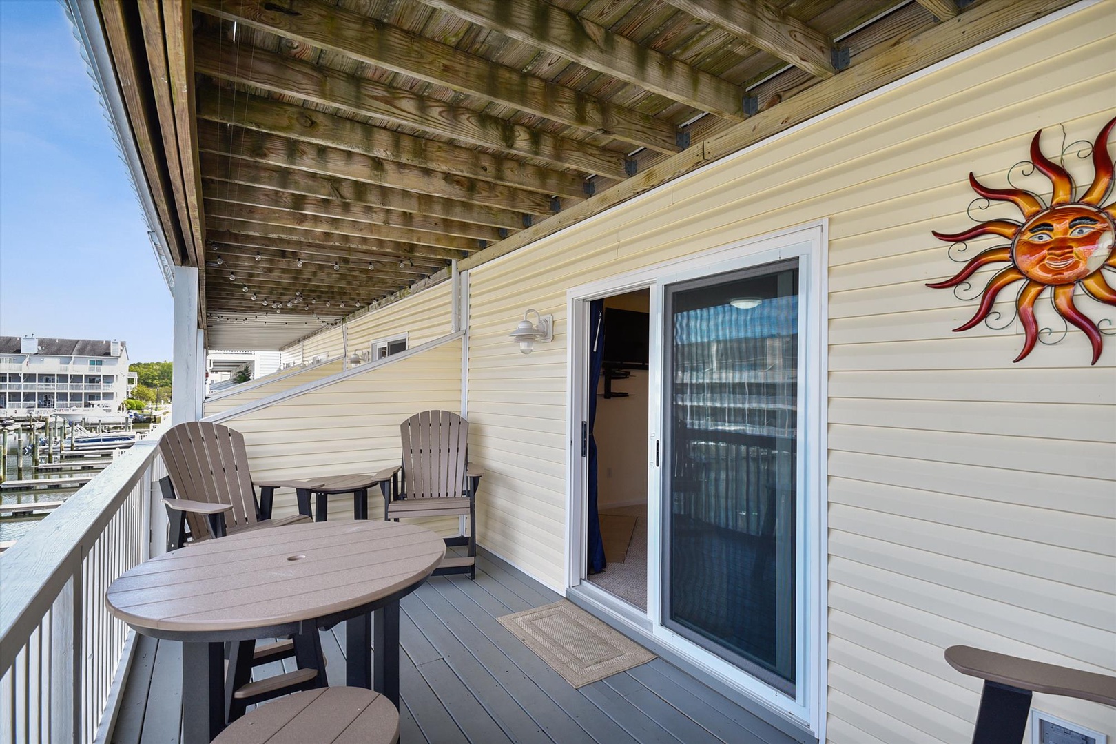 Step onto your private covered balcony with water views and cozy seating. Picture yourself relaxing in the shade, sipping morning coffee as boats drift by—your peaceful retreat awaits.