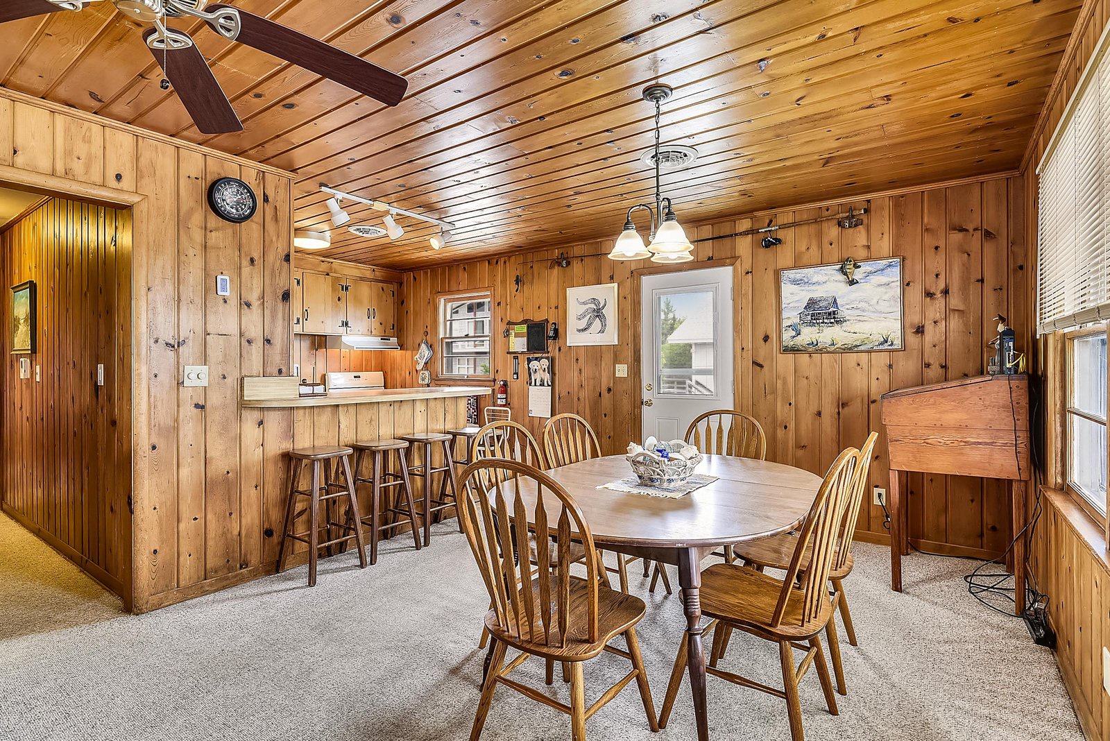 Rustic charm meets warmth with wood-paneled walls and elegant lighting. Perfect for morning coffee or evening meals, plus a cozy bar area ideal for planning your next adventure.