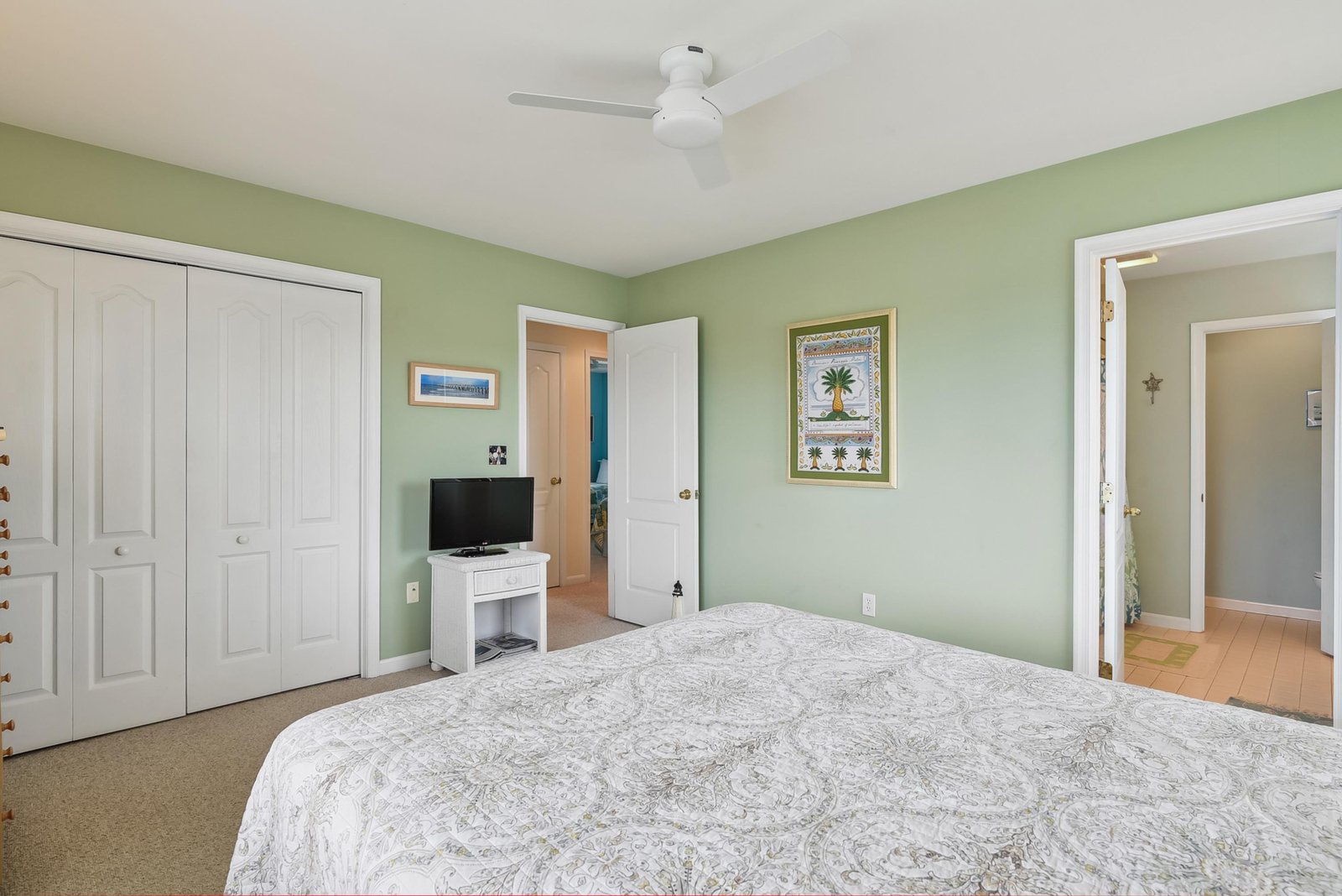 Soft coastal tones and a calming breeze from your ceiling fan set the mood for restful nights in this spacious bedroom. Enjoy plenty of storage and a private ensuite—perfect for unwinding after beach days.