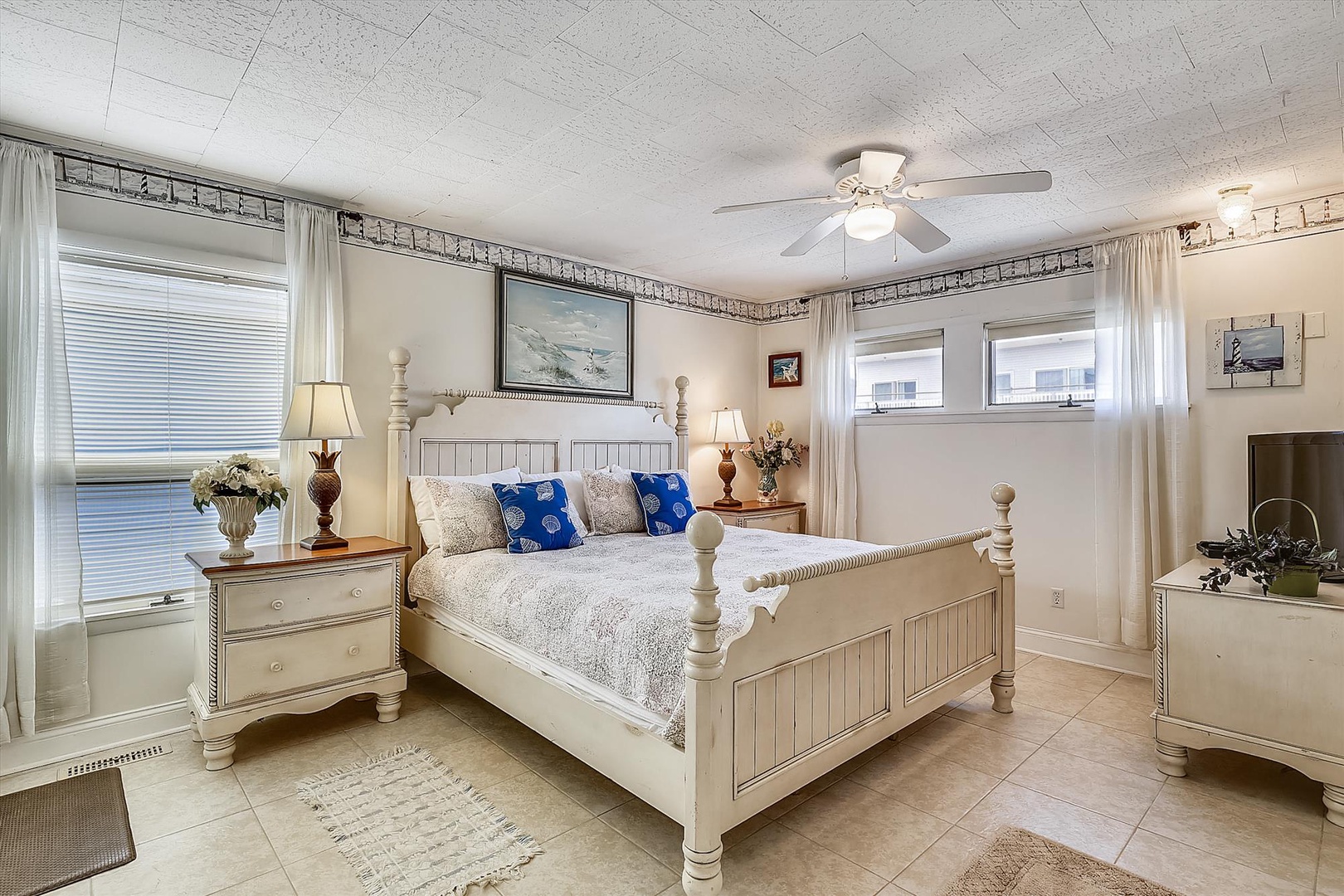 Drift off in your peaceful bedroom retreat with coastal charm—plush linens, nautical touches, and soft lighting create your perfect sanctuary.