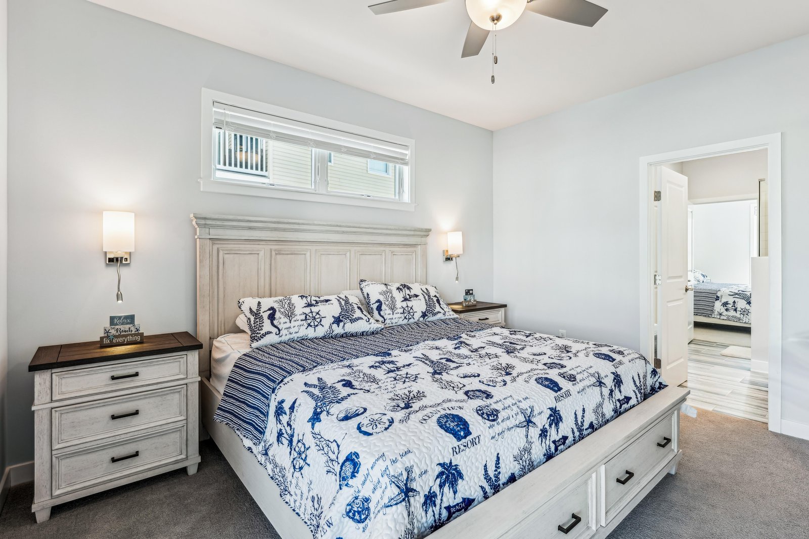 Sink into the coastal-inspired bed and let the soft glow of bedside lamps set a serene mood for your evening retreat.