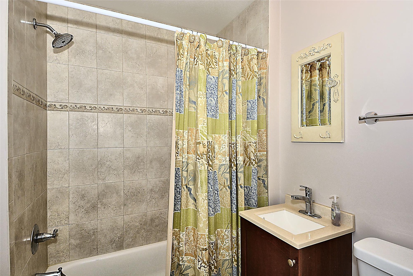 Enjoy your freshly updated bathroom with elegant tiled shower, modern fixtures, and cheerful décor—everything you need to feel right at home.
