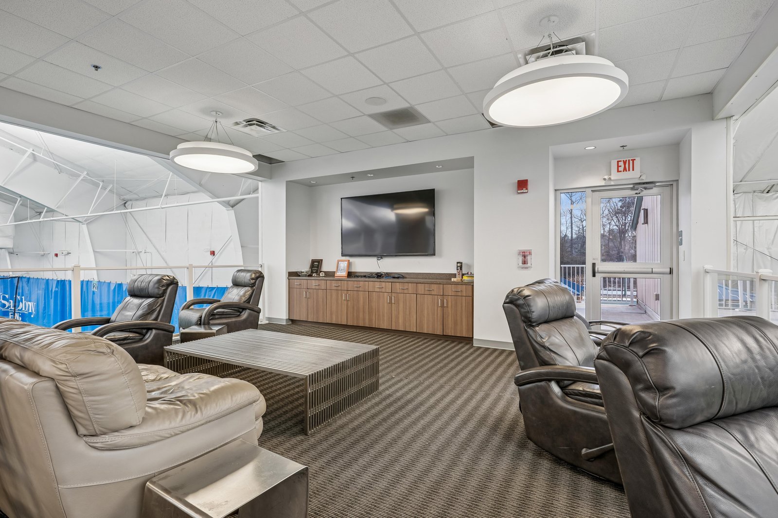 Settle into plush leather recliners and gather with fellow travelers in this bright communal lounge, complete with a large screen and coffee station for your convenience.