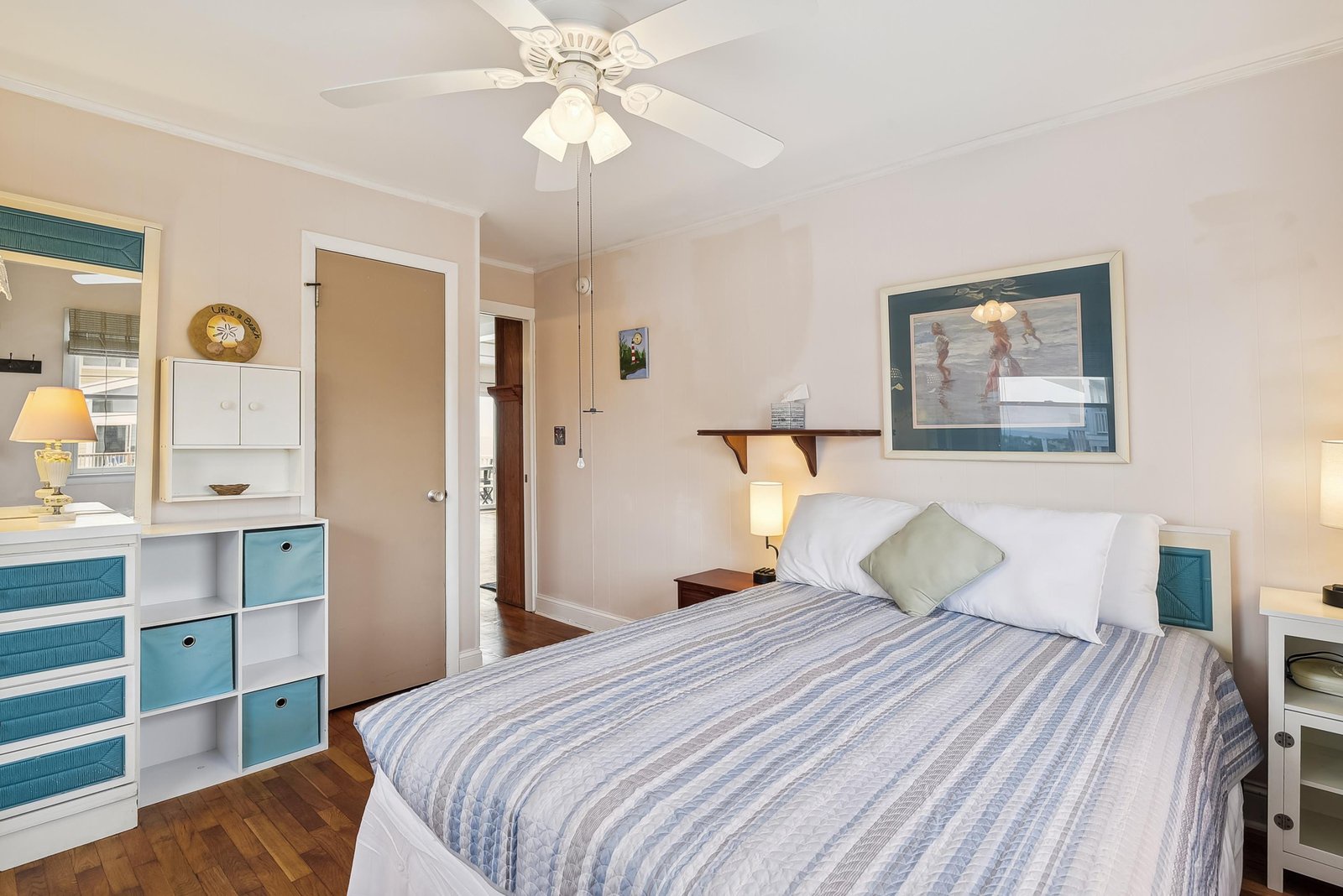 Drift off in your cozy coastal bedroom, where soft linens and gentle ceiling fan breezes create a restful retreat after your beach adventures.