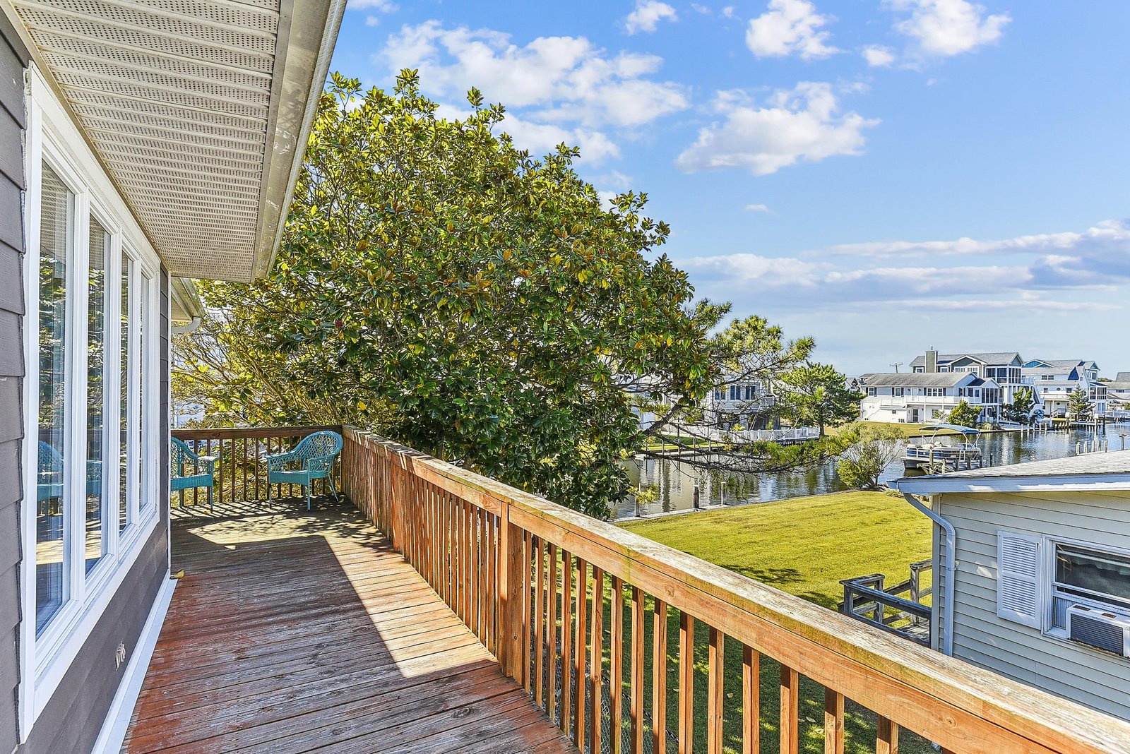A spacious wraparound deck offers tranquil waterfront views over the canal and neighboring homes, a perfect spot to sip morning coffee or watch boats drift by.