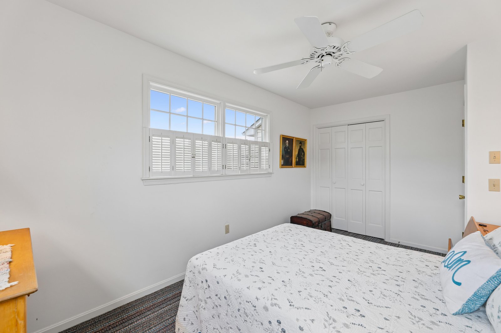 Your bright, airy bedroom awaits with a comfortable bed, ceiling fan for gentle breezes, and plenty of closet space to settle in and unwind.