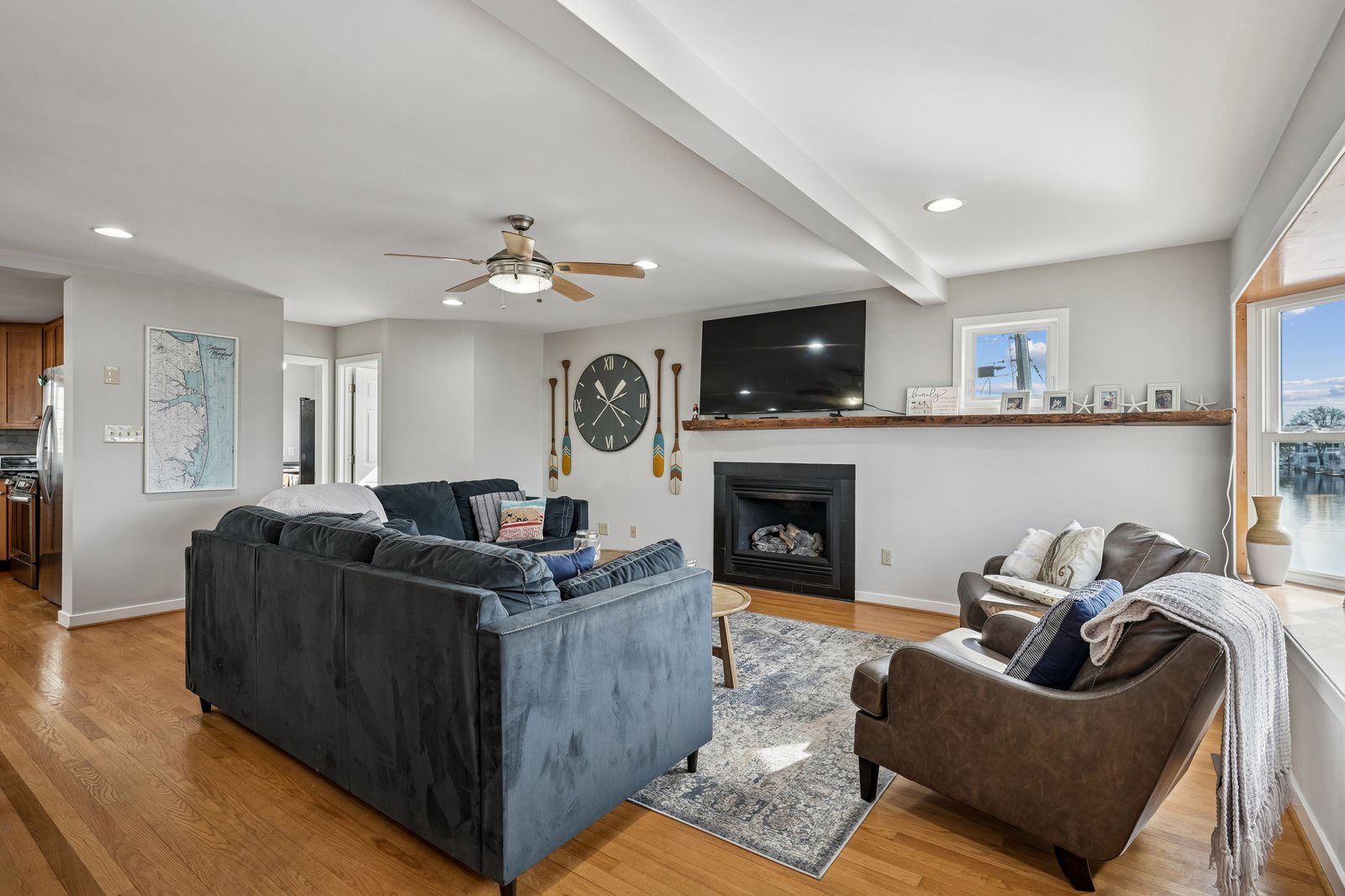 Sink into plush sofas by your cozy fireplace, where warm wood floors and thoughtful touches create the perfect retreat.