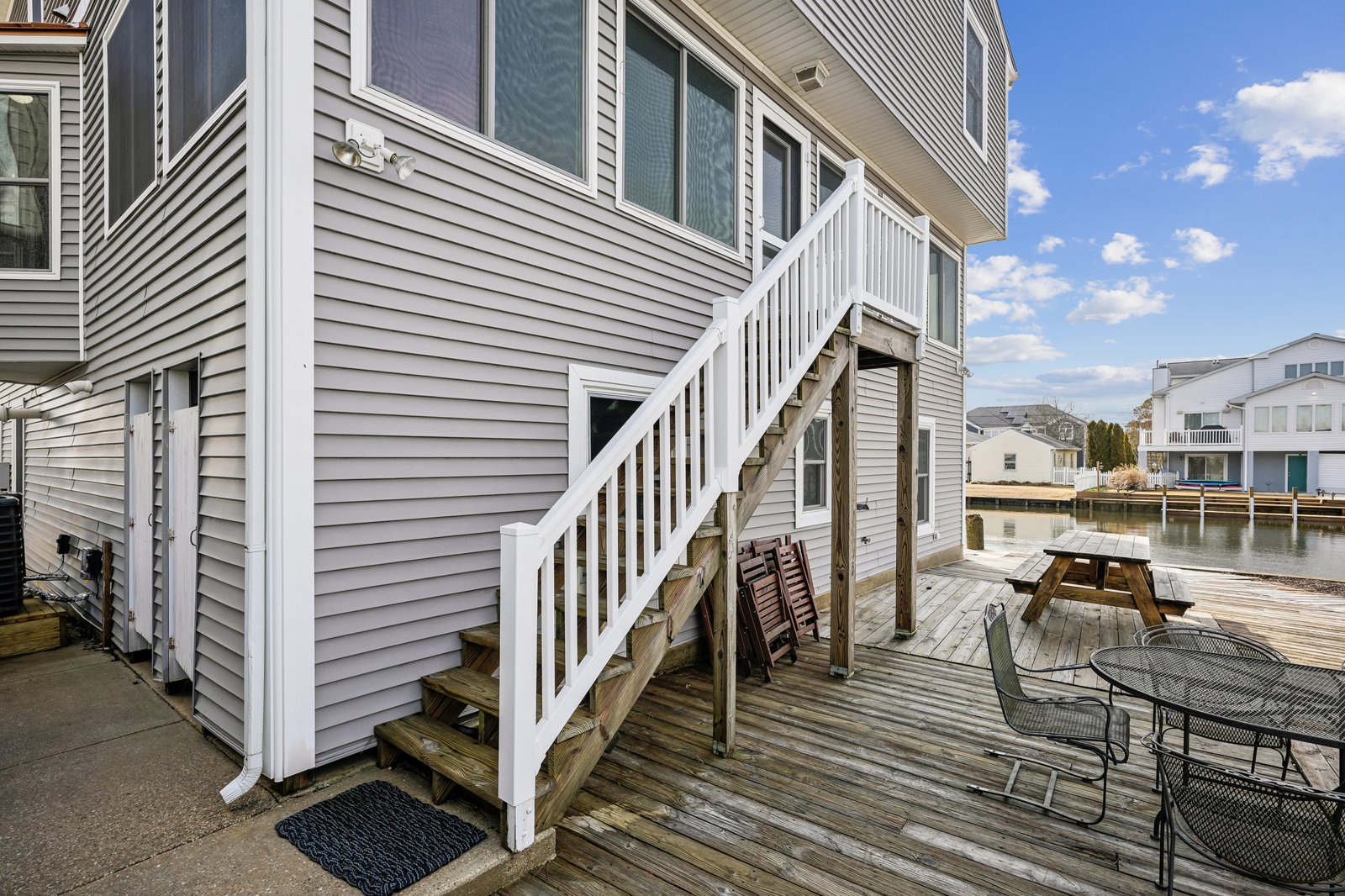 Step onto your private waterfront deck where outdoor dining and peaceful canal views create the perfect retreat.