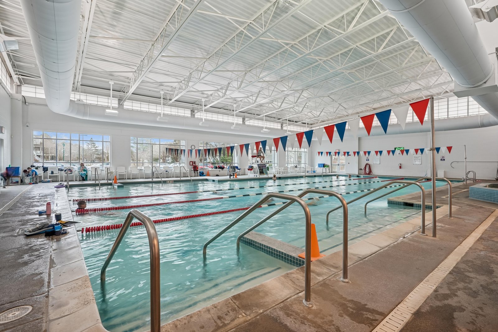 An indoor swimming pool facility with multiple lanes for swimming and recreational activities, offering a temperature-controlled environment year-round.
