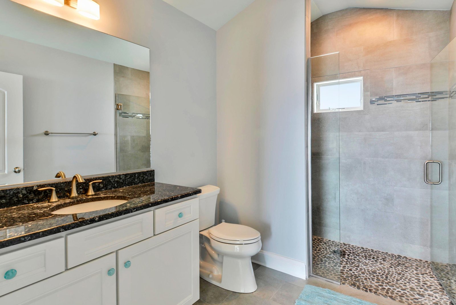 Sleek granite counters and a spacious walk-in shower with beautiful tilework invite you to refresh and unwind in style.
