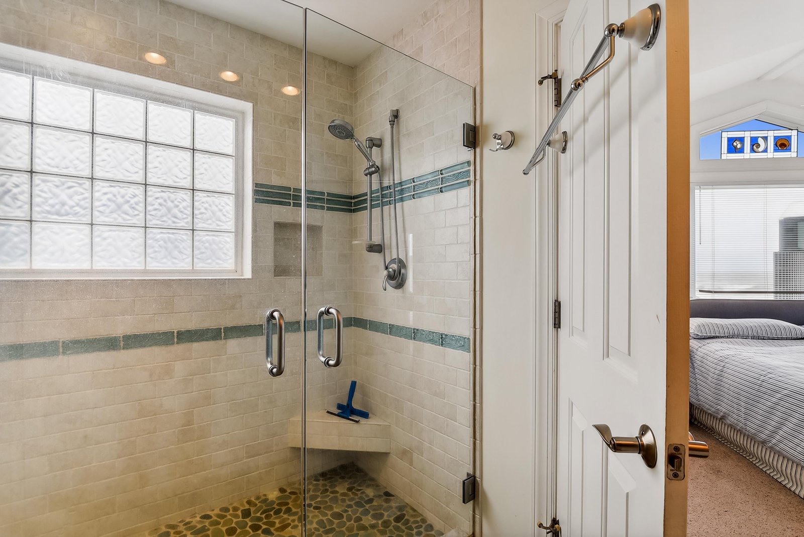 Step inside your spacious walk-in shower with spa-inspired stone floor, dual showerheads, and stylish tile details designed for a refreshing start to your day.