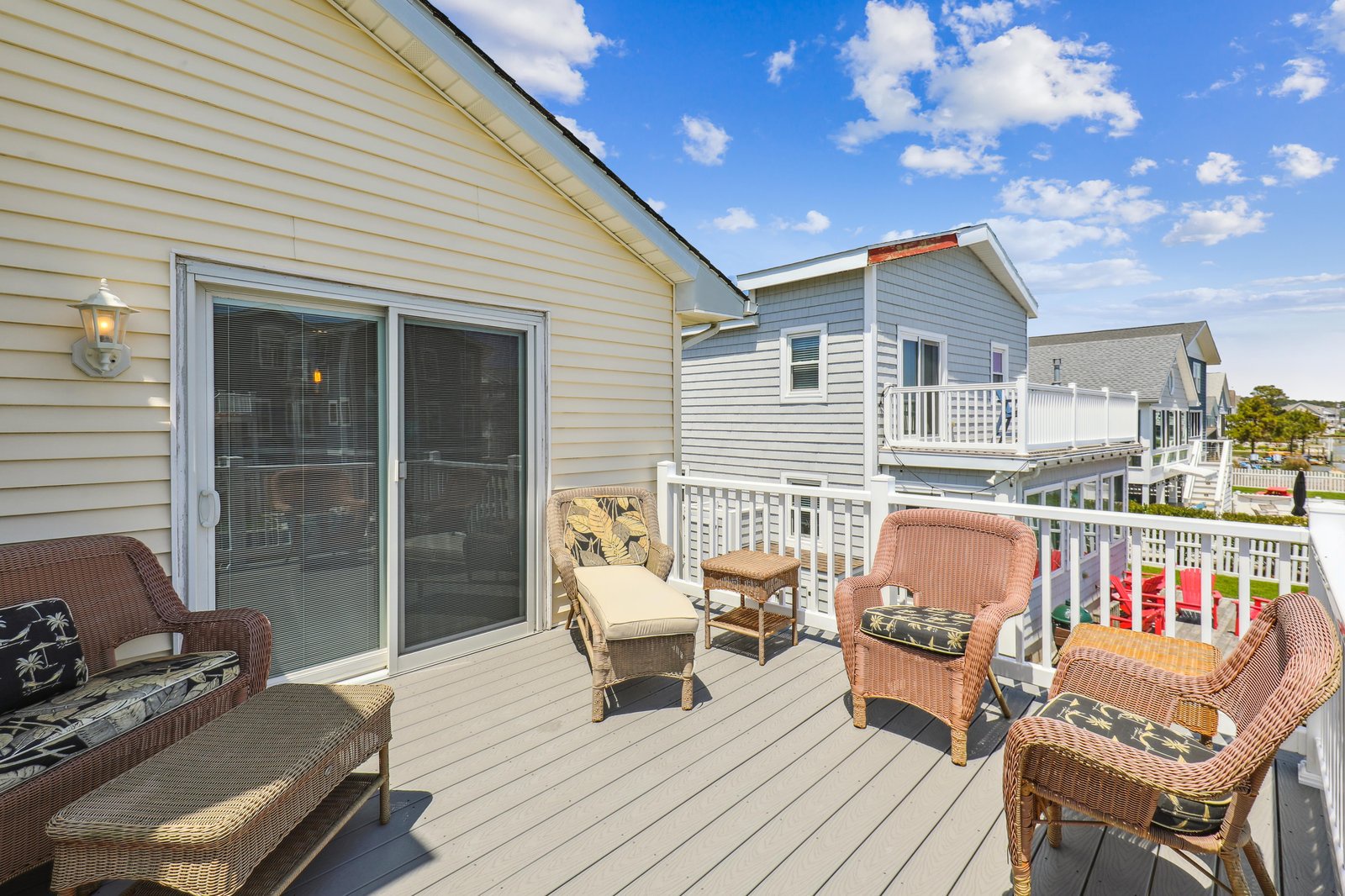 This sunny deck offers the perfect spot for relaxing outdoors, complete with comfortable seating where you can soak up the fresh air and blue skies.