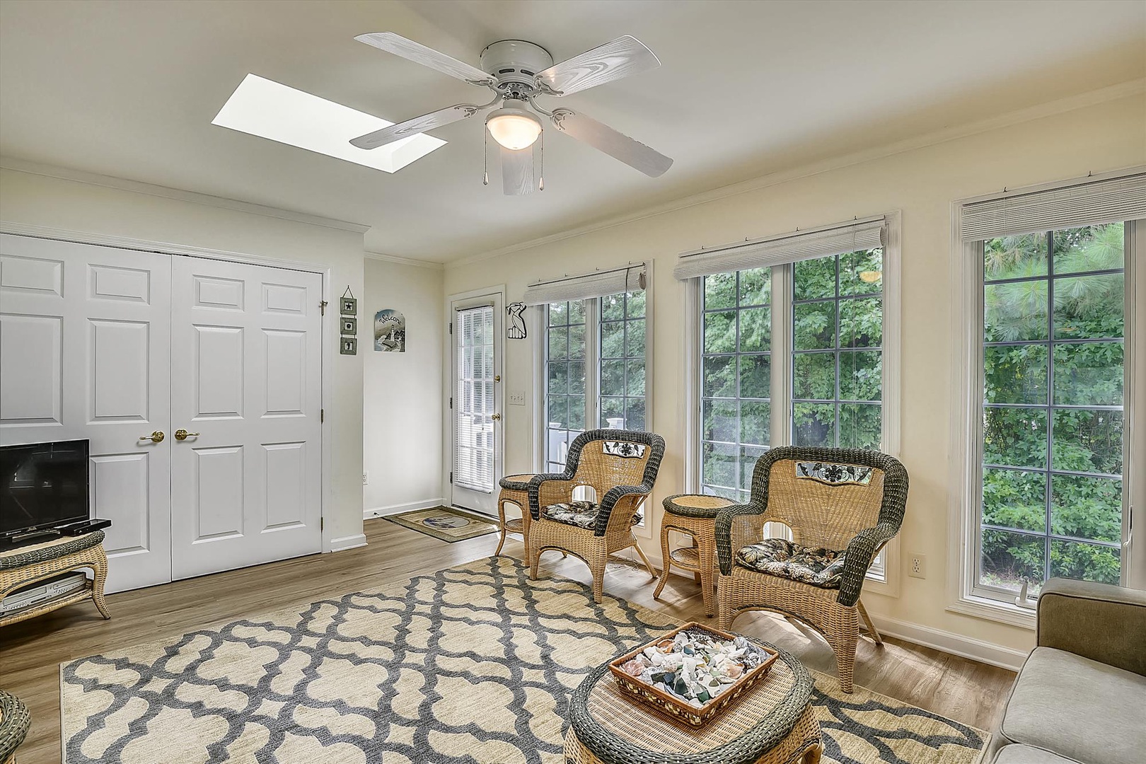Relax in your bright sunroom with wicker seating, garden views through expansive windows, and a ceiling fan to keep you cool on warm afternoons.