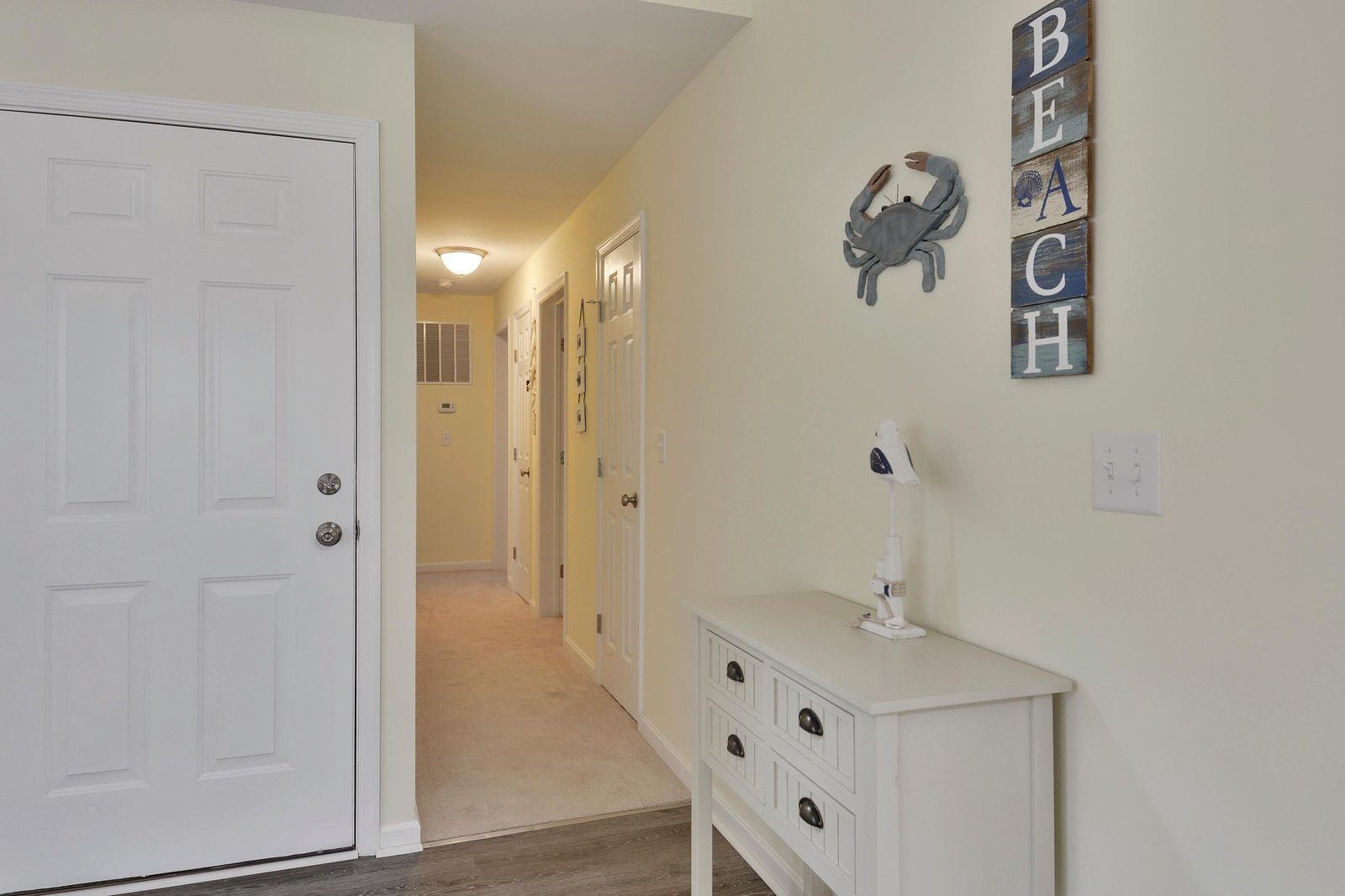 Step inside to a bright, welcoming entryway that sets the tone for your beach getaway. Coastal touches remind you you're just moments from the shore.