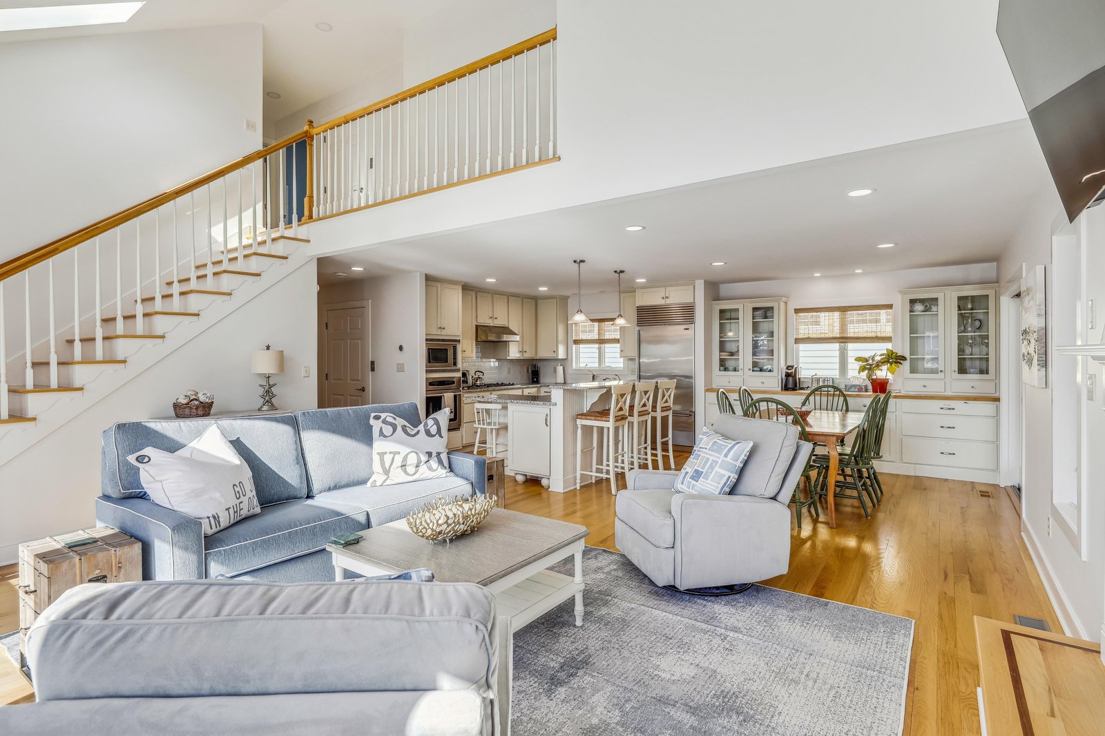 Settle into this bright, open-concept living space where airy coastal tones and natural light welcome you home. The seamless flow from living room to kitchen invites your family to gather, cook, and unwind together.