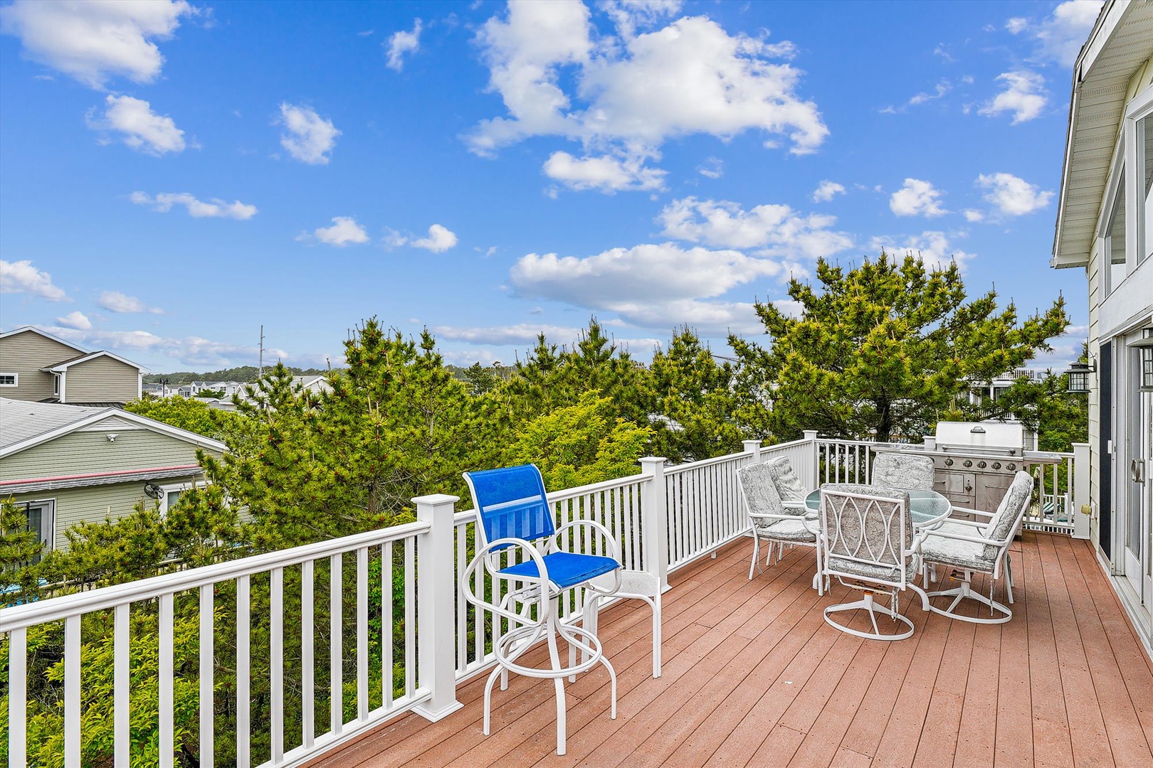 Picture yourself grilling dinner on your private deck with comfortable seating, a built-in BBQ, and lush tree-lined views stretching beyond—perfect for morning coffee or evening unwinding.