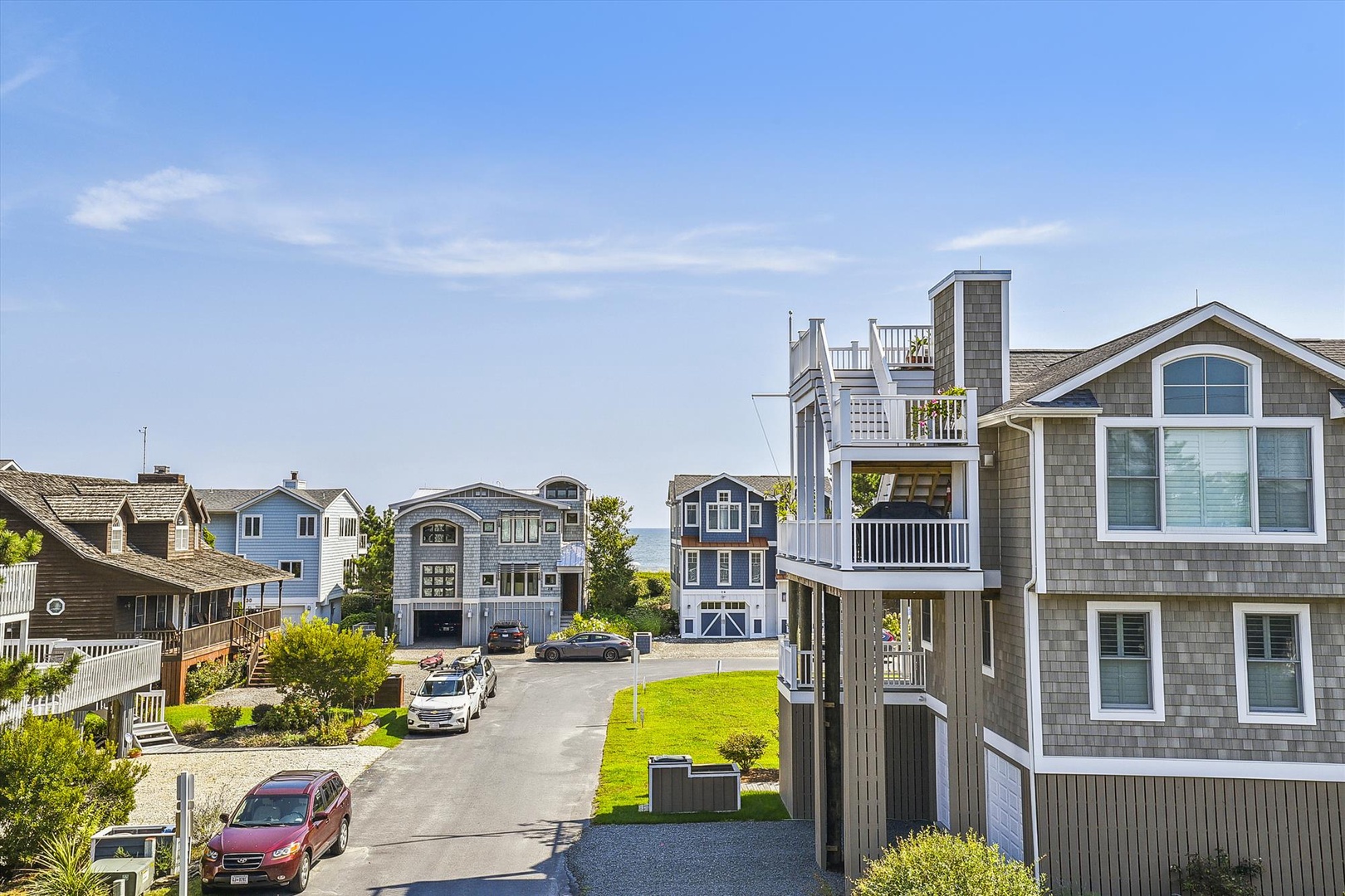 Charming coastal neighborhood with beachside architecture and ocean views. The property is nestled among well-maintained vacation homes, offering a peaceful retreat just steps from the shore.