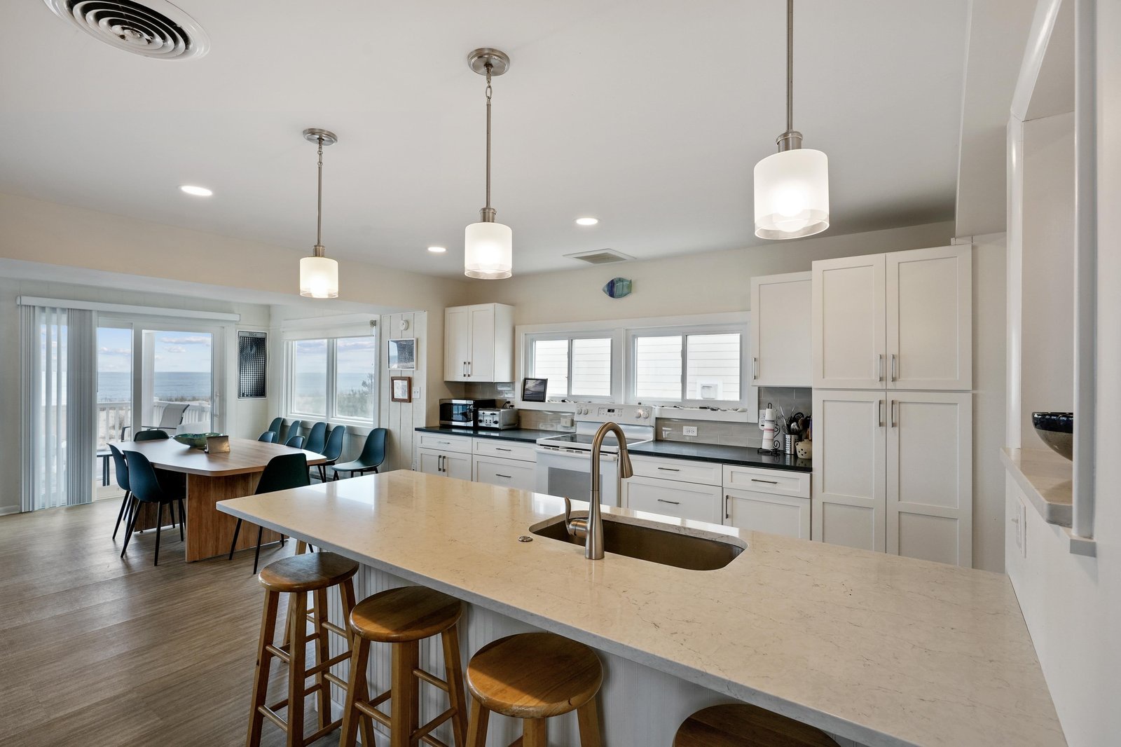Step into your open-concept haven where a spacious kitchen island invites you to gather, cook, and unwind. Natural light floods the room while ocean breezes drift in from the balcony, making every meal feel like a coastal escape.