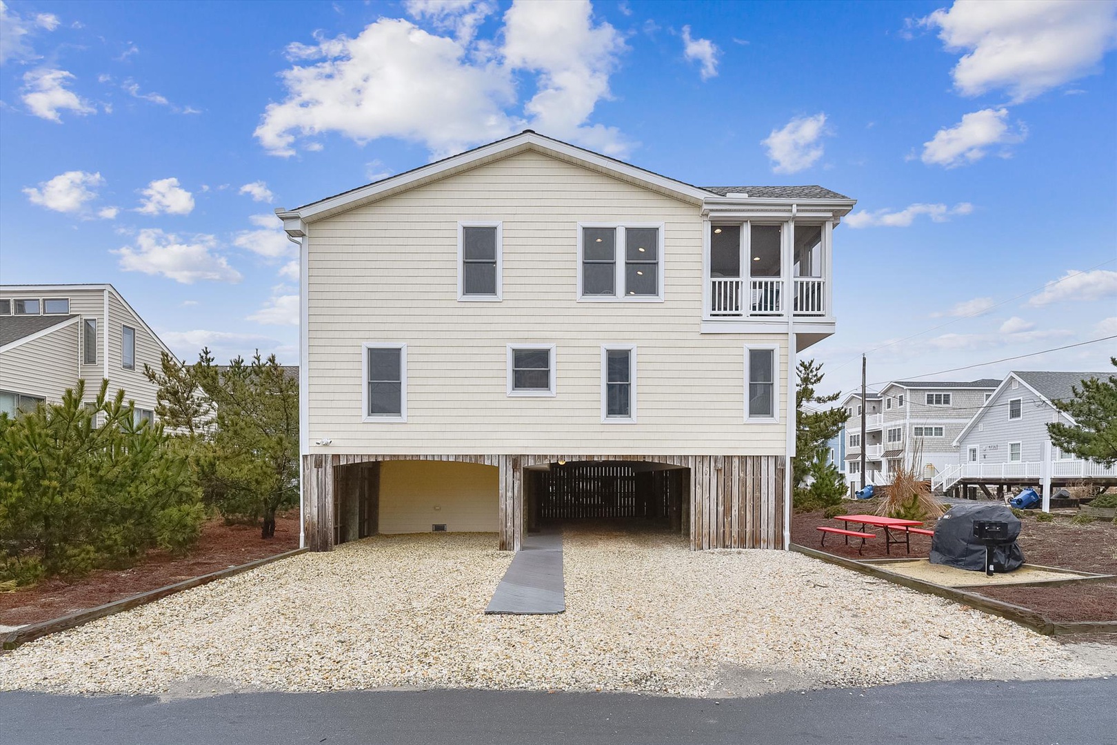 This two-story coastal rental features elevated construction, covered parking, and a private balcony with an upper-level porch. Located in a peaceful beach neighborhood just moments from the shore.