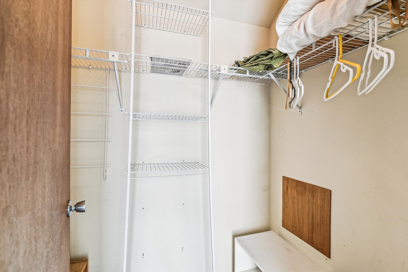 Your private walk-in closet offers ample shelf space and hanging rods to keep your wardrobe organized and easily accessible throughout your stay.