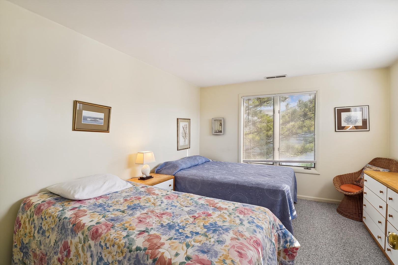 Your comfortable bedroom features two cozy beds, soft natural light from large windows, and thoughtfully chosen decor to help you unwind after a day of exploring.