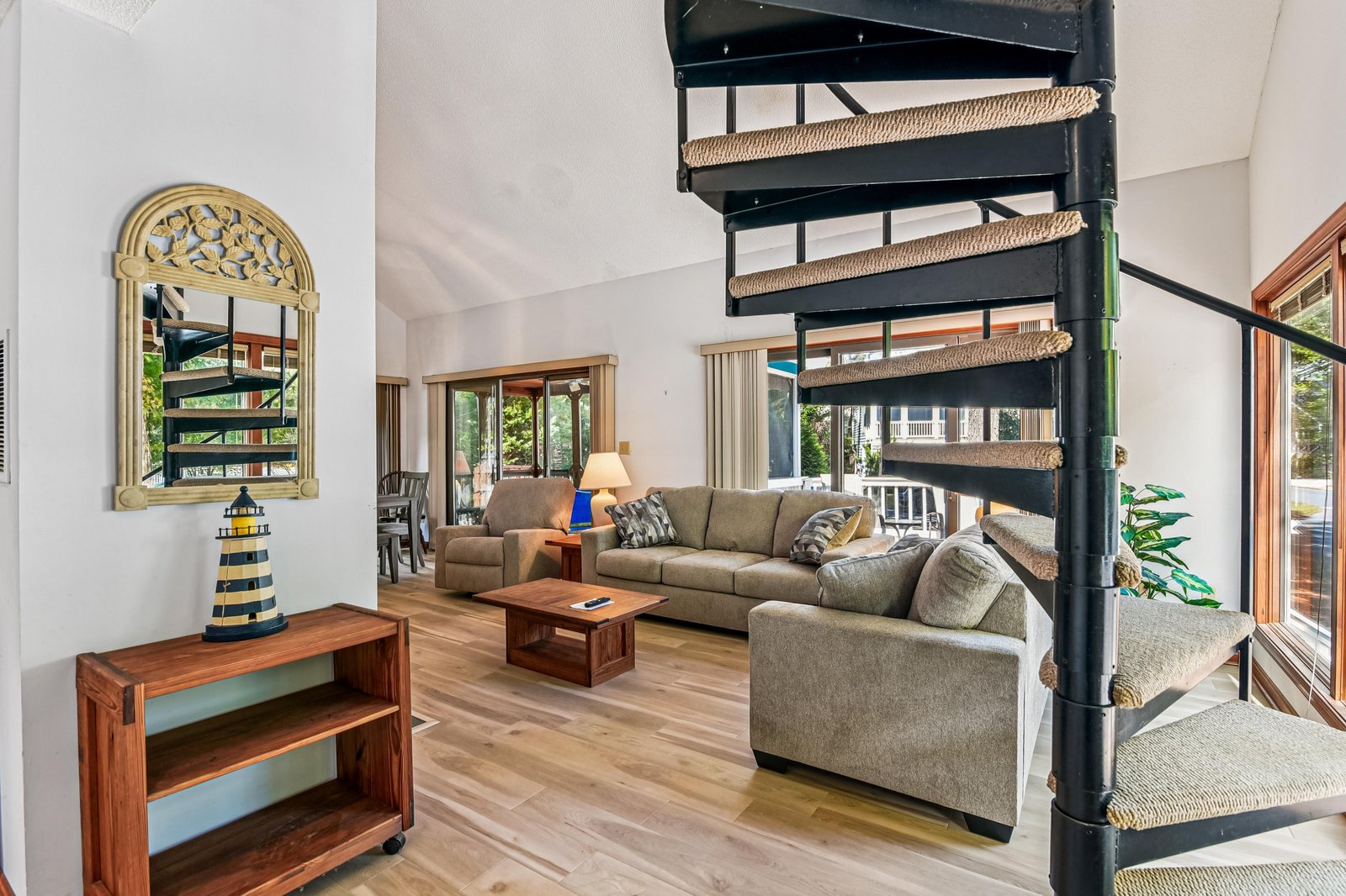 Relax in your bright, open living space with soaring ceilings and a striking spiral staircase that connects your private levels.