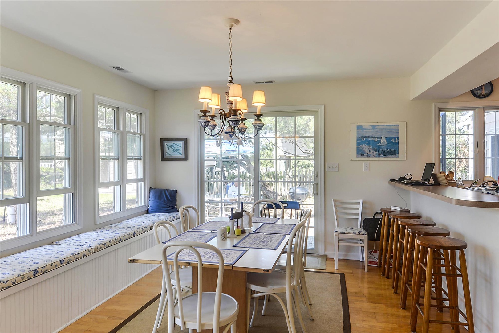 Gather around the coastal-inspired dining table for morning coffee or family meals as sunlight streams through the windows, overlooking your peaceful surroundings.