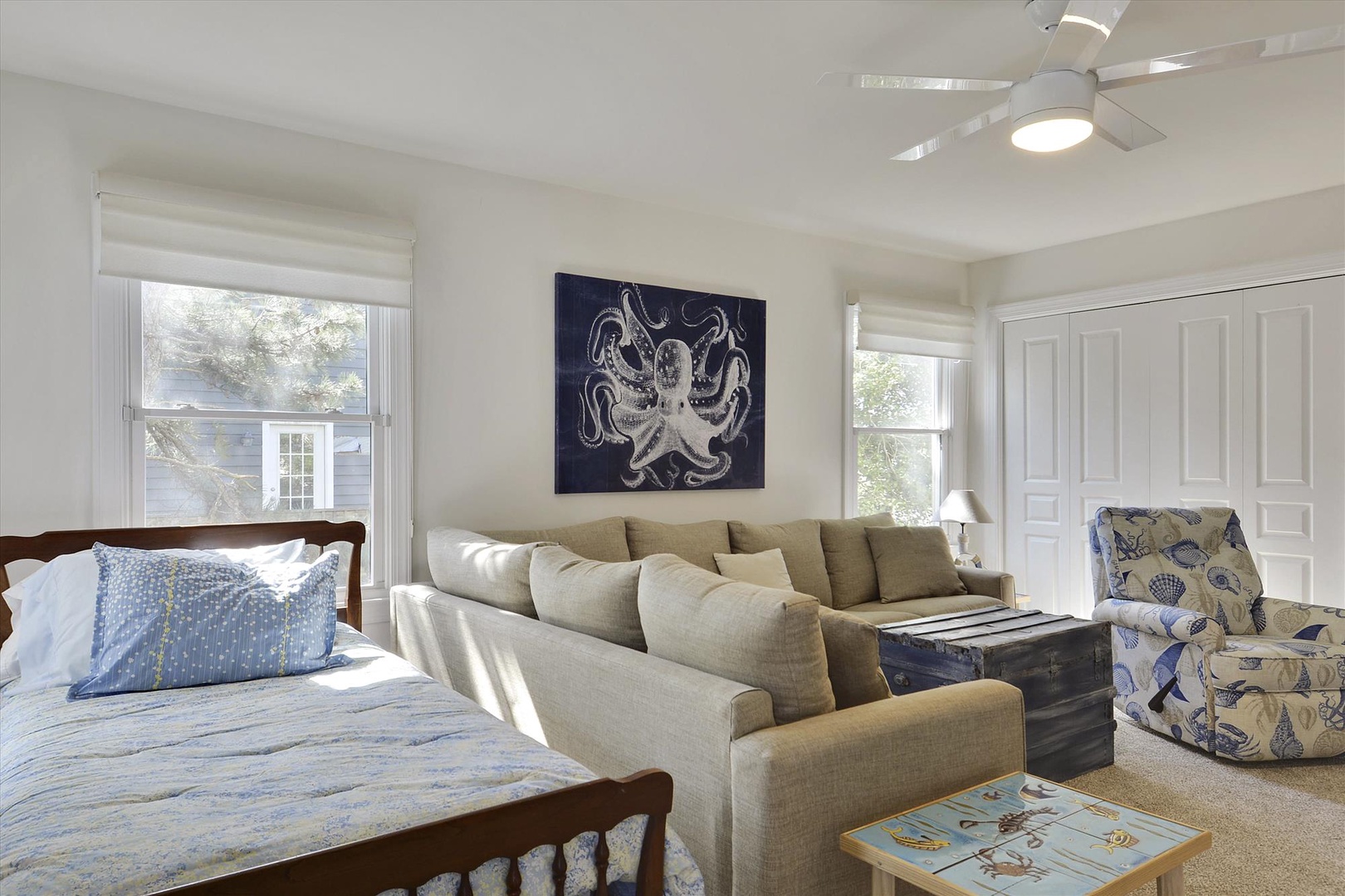 Your bright coastal retreat features a comfy sectional for lounging, ceiling fan for breezy comfort, and ocean-inspired décor that sets a relaxing seaside mood.