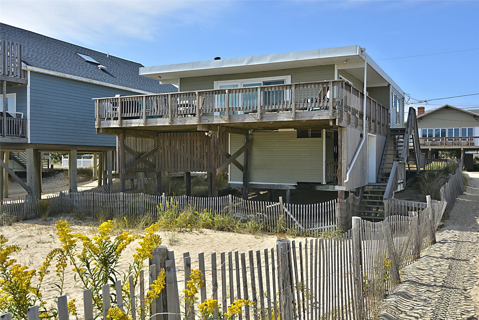 Beachfront rental elevated on sturdy pilings, offering direct sandy access and a spacious balcony overlooking the shore—ideal for a coastal getaway.