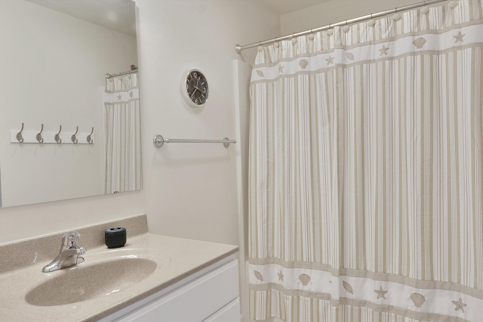 A bright, spotless bathroom with coastal charm and thoughtful touches to make your stay comfortable and refreshing.
