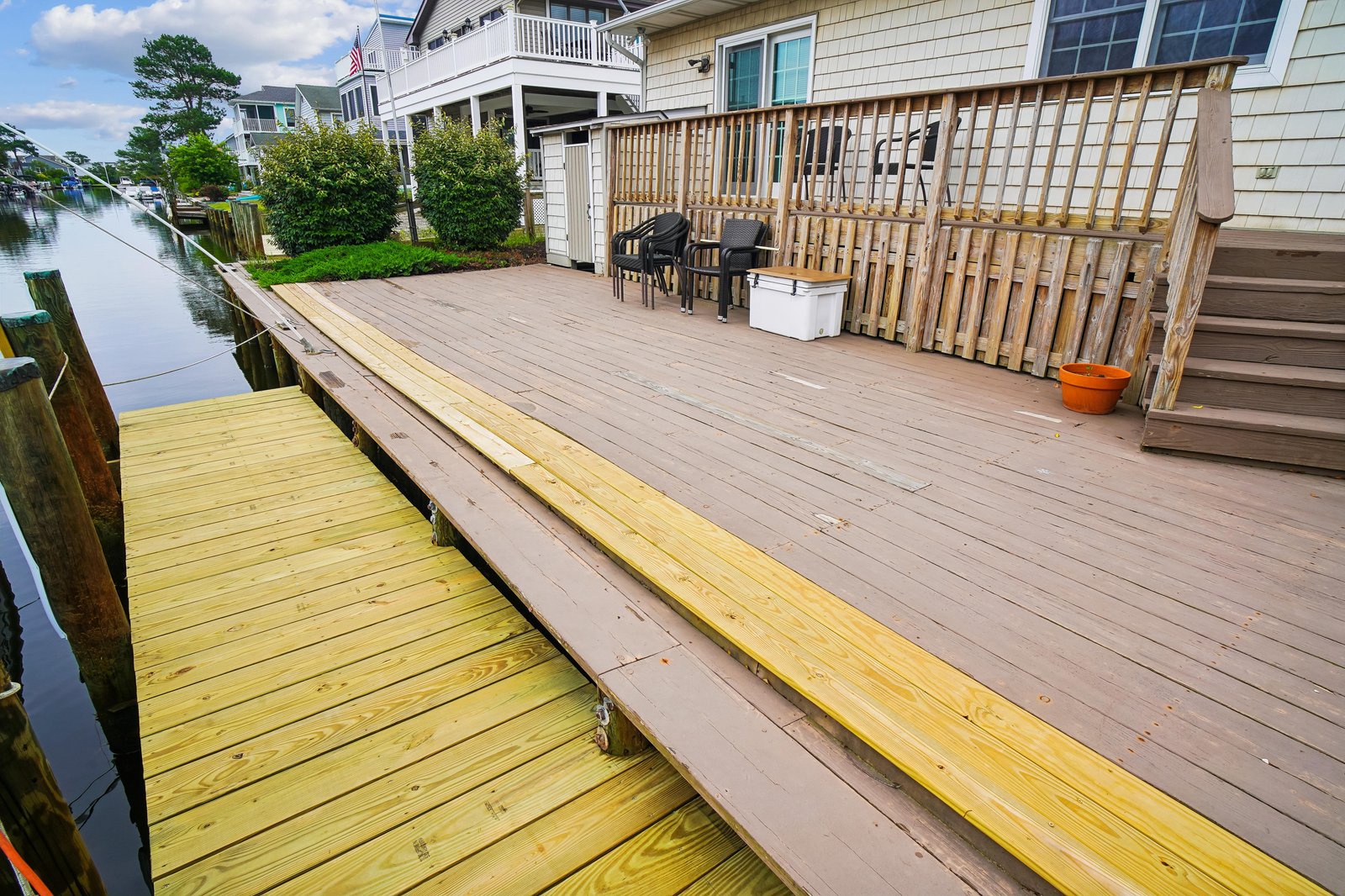 Spacious waterfront deck with dining area and private dock, ideal for morning coffee or sunset grilling. The calm canal invites kayaking or fishing right from your doorstep.