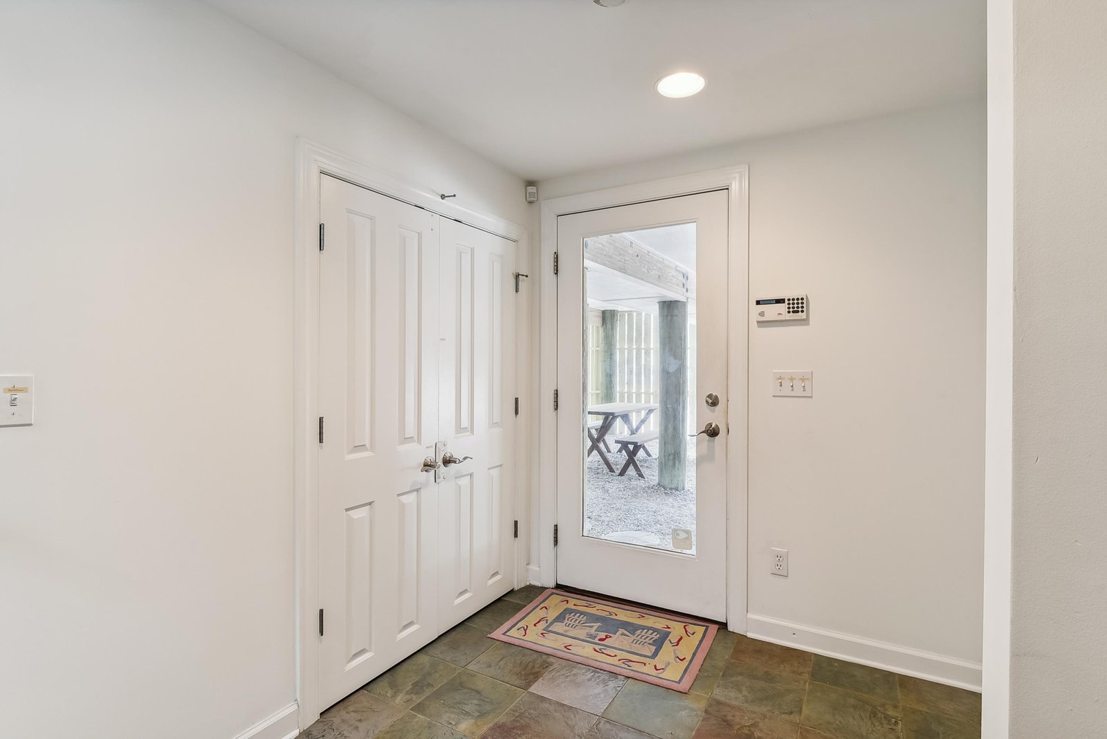 Step through the glass door into your bright, welcoming entry. The cheerful mat and clean tile floor set the tone for a relaxing coastal getaway.
