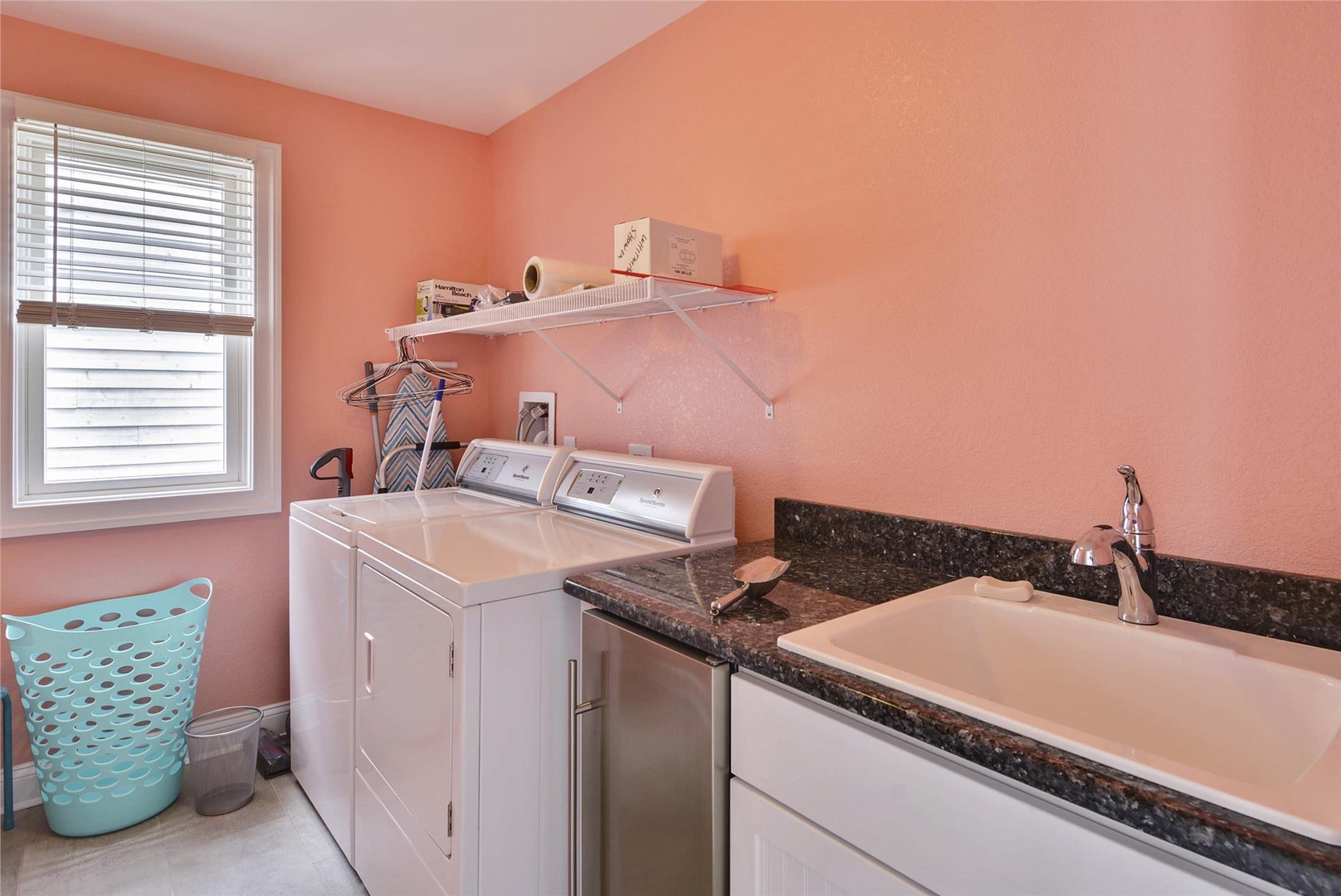 Your own dedicated laundry space with full-size washer and dryer, plus a handy sink and counter for all your sorting and folding needs.