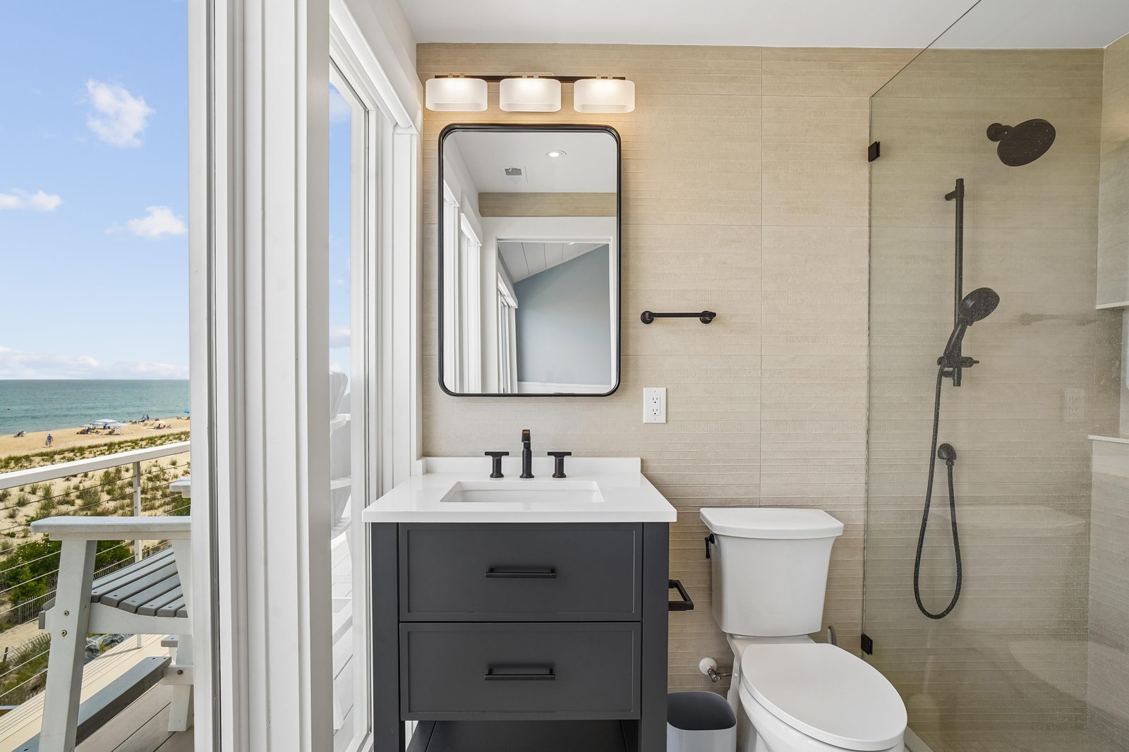 Step into your private bathroom where ocean breezes meet coastal calm—your balcony opens to stunning beach views, making every refresh feel like a seaside escape.