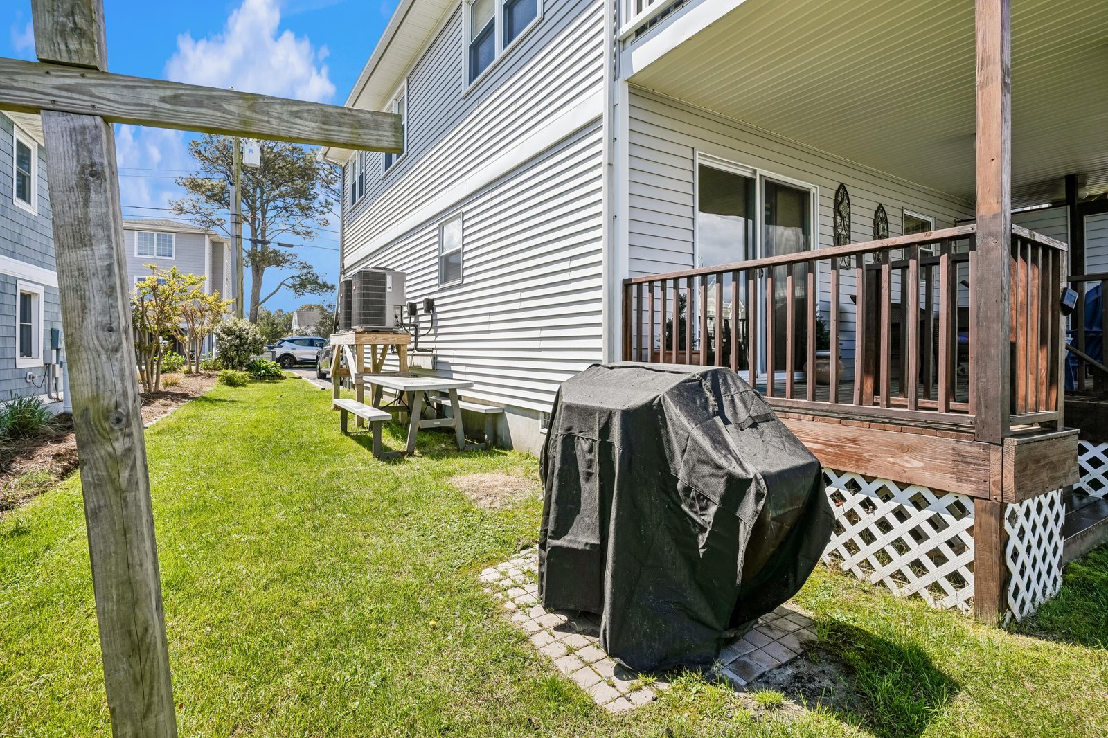 Your private backyard with covered deck, picnic table, and grill awaits—perfect for morning coffee or sunset dinners after a day of coastal adventures.