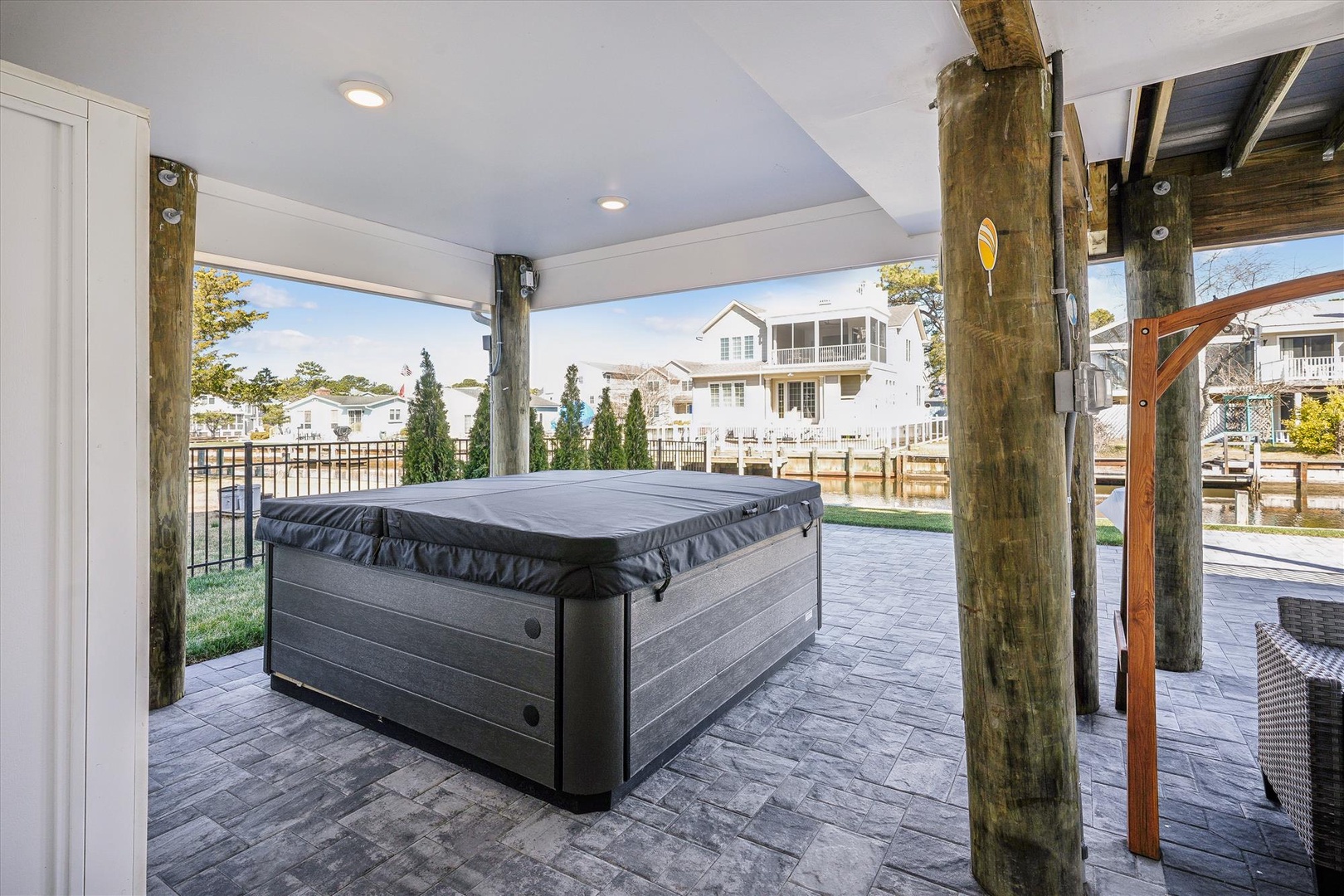 Soak your cares away in your private hot tub while enjoying peaceful neighborhood views from this covered outdoor sanctuary.