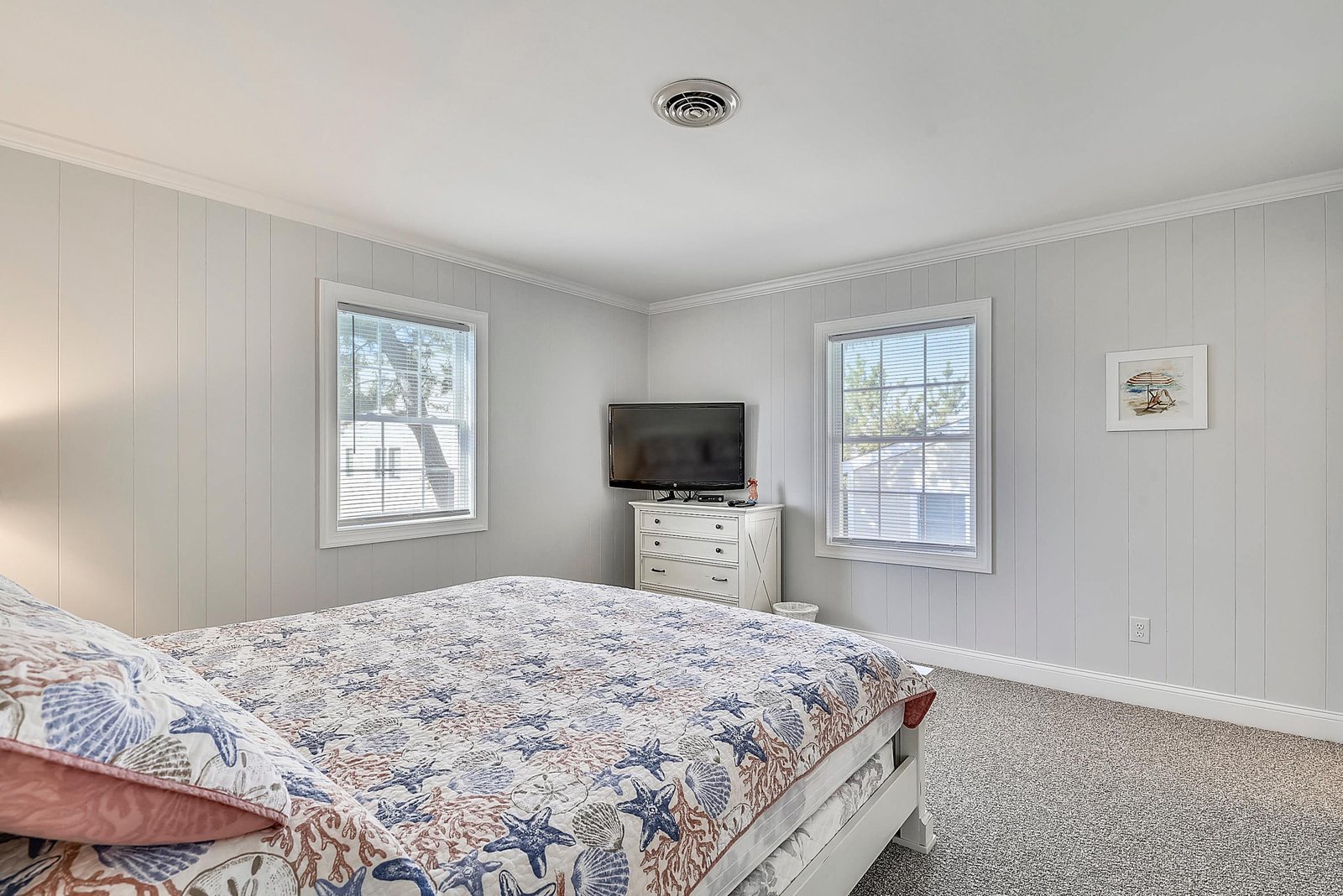 Drift off in this serene bedroom where soft coastal tones and natural light create your perfect sanctuary for rest and relaxation.