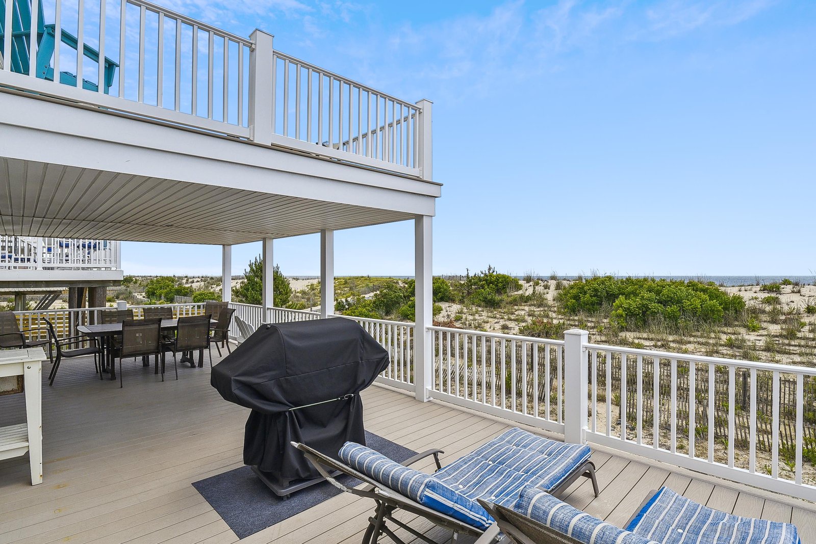 Step out to your private deck and soak in the natural coastal landscape stretching before you. Loungers and a grill invite you to unwind outdoors, while the covered space ensures comfort whatever the weather.
