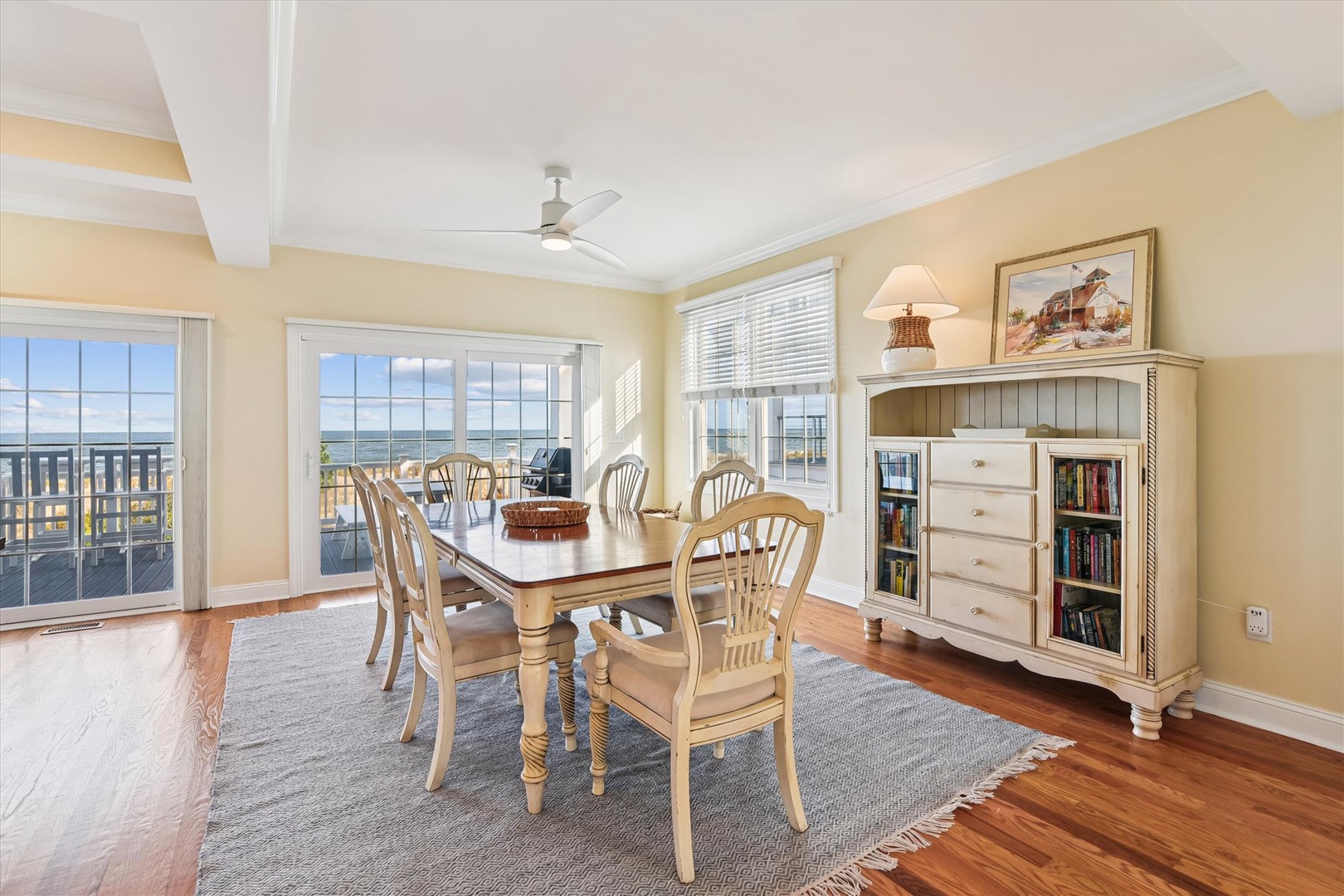 Gather around the dining table with coastal views framing your mornings. Warm hardwood floors and soft natural light create the perfect space for memorable meals overlooking the beach.