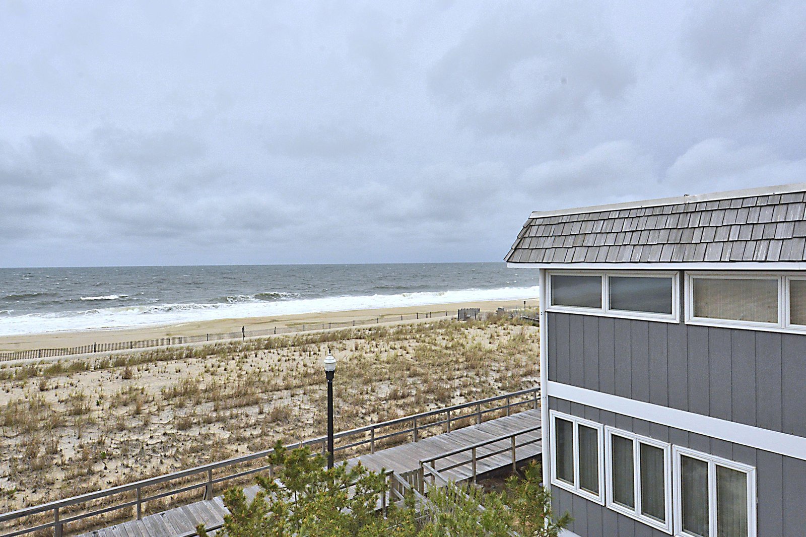 Beachfront property with direct ocean access and sandy shoreline, offering a prime coastal location just steps from the waves.