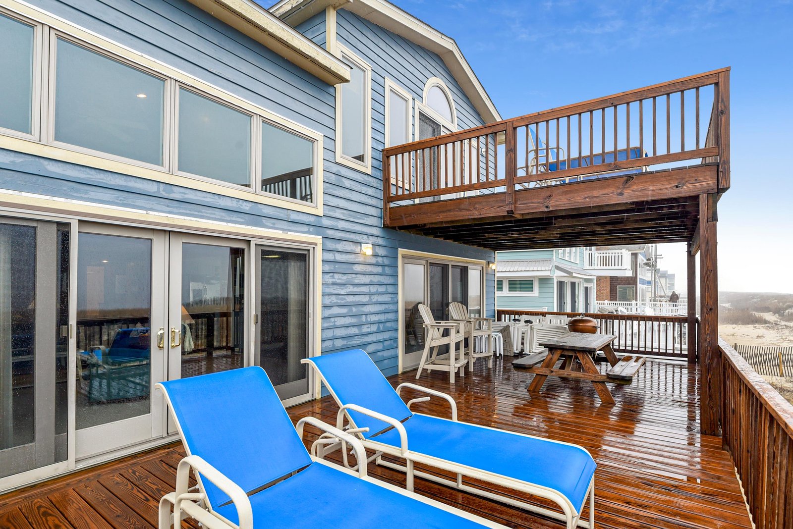 A spacious multi-level deck with lounge chairs and dining spaces where you can soak up the coastal breeze and watch the day unfold over the water.