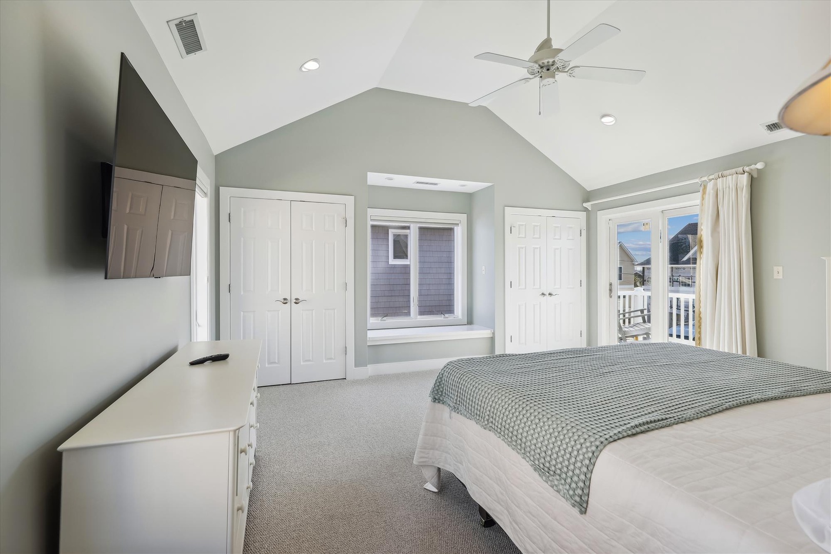 Your spacious bedroom features vaulted ceilings, soft natural light, cozy linens, and a private balcony where you can step out to enjoy peaceful neighborhood views.