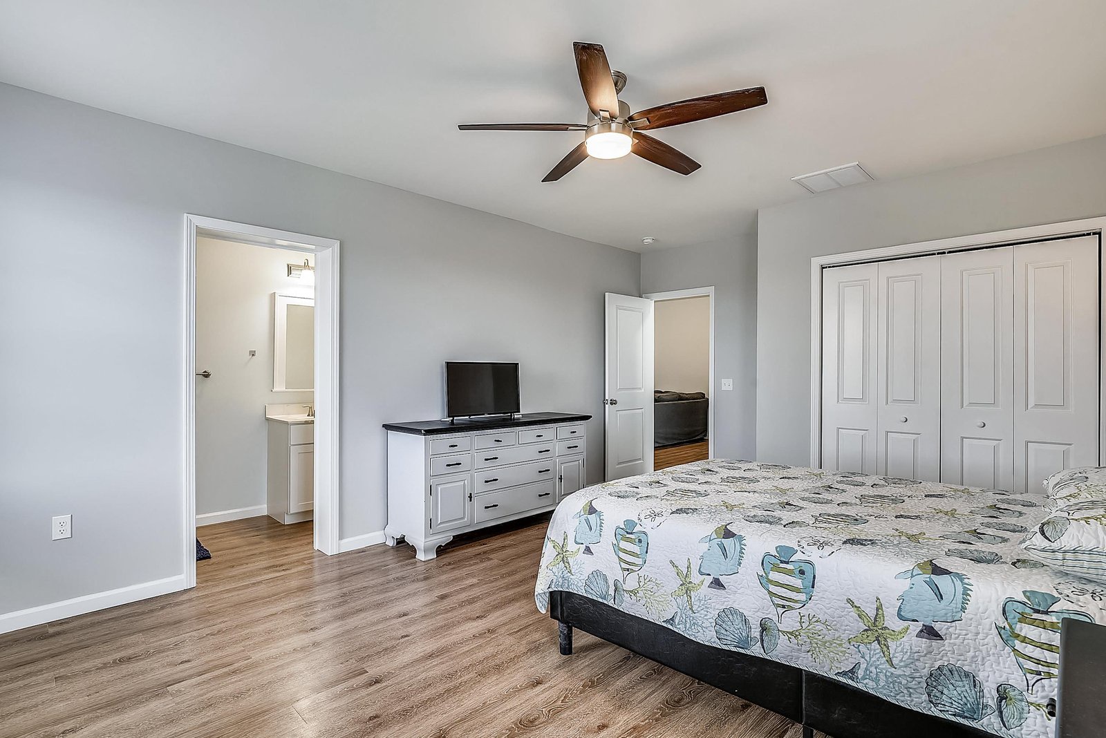 Your spacious bedroom invites restful nights with soft bedding, a ceiling fan for comfort, and an ensuite just steps away for your convenience.